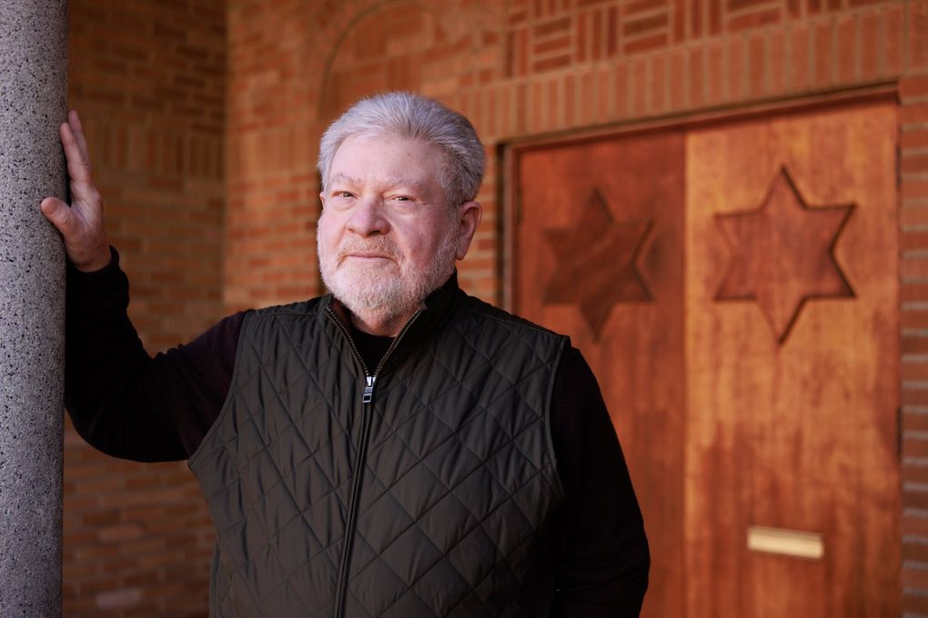 Joel Benoliel outside of Tolliver Temple Church of God in Christ in Seattle. The historic building was originally built as the Sephardic Bikur Holim synagogue, and Stars of David can still be seen on its doors. (Erika Schultz / The Seattle Times)