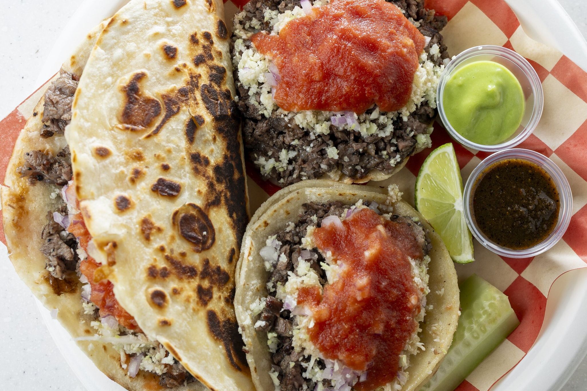 Quesadilla (left), vampiro (top) and tacos available at Tacos Cometa on a Friday afternoon in Seattle. (Kevin Clark / The Seattle Times)