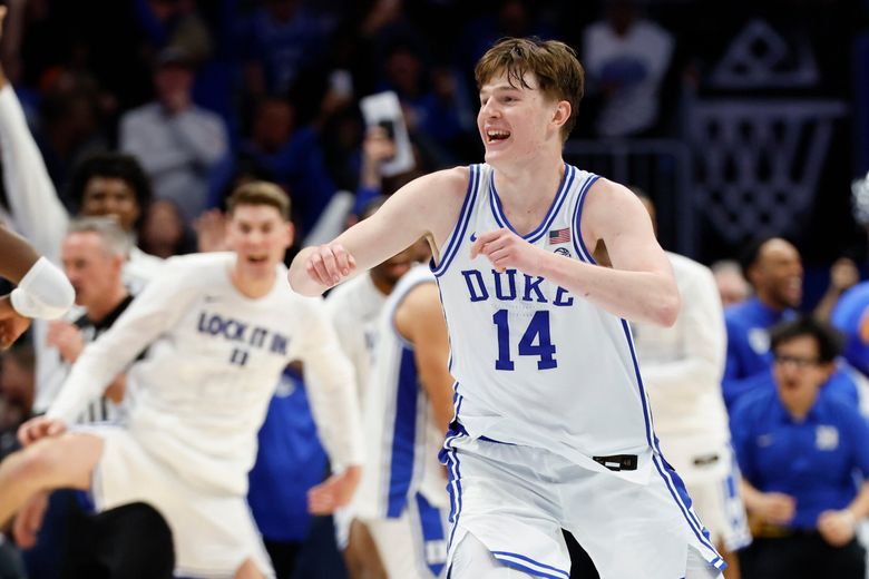 Duke guard Nikolas Khamenia (14) celebrates as the Blue Devils defeat Virginia in the championship game of the Atlantic Coast Conference tournament Saturday. (Nell Redmond / The Associated Press)