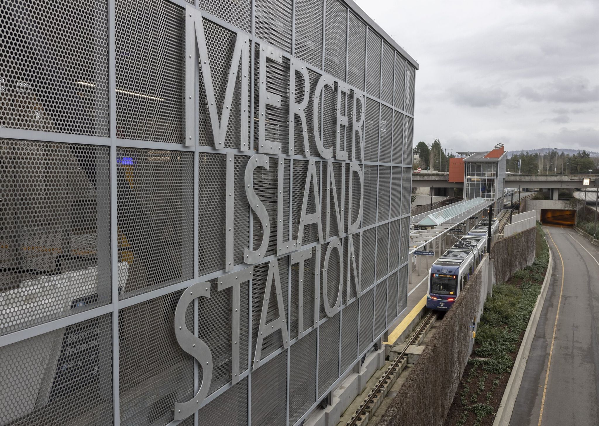 A light rail train on a test run stops at Mercer Island station. Residents fought Sound Transit for years over this station. (Ellen M. Banner / The Seattle Times)