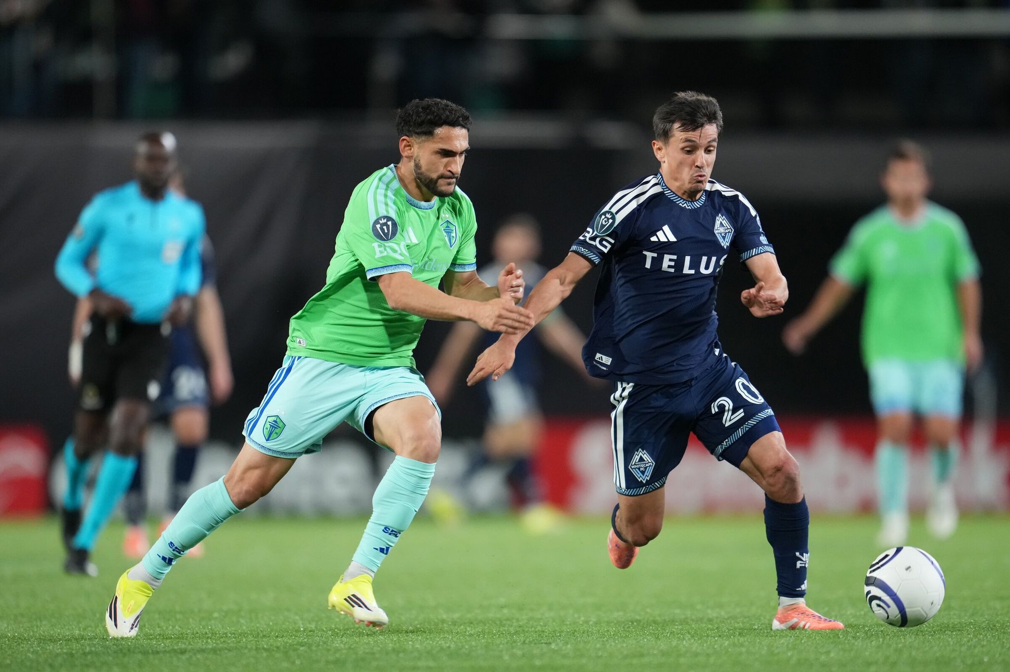 Sounders midfielder Cristian Roldan, left, battles with Vancouver’s Andrés Cubas during their CONCACAF Champions Cup match Wednesday in Spokane. (Sandra Agbotse / Sounders FC)