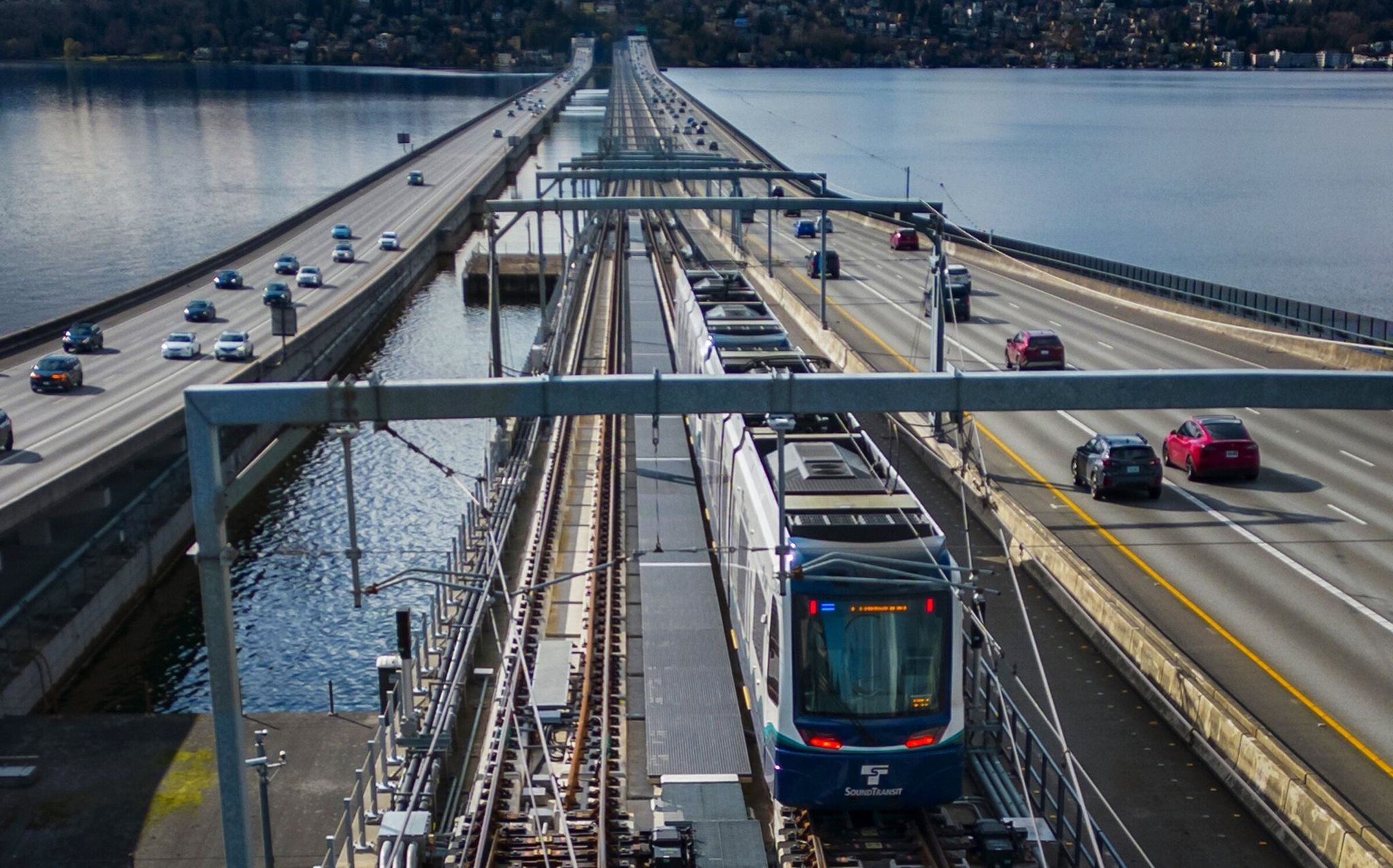 A light-rail train crosses Lake Washington during a test run. This route is the first in the world to travel over a floating bridge. Line 2, running from Lynnwood to Redmond, opens on Saturday. (Ellen M. Banner / The Seattle Times)