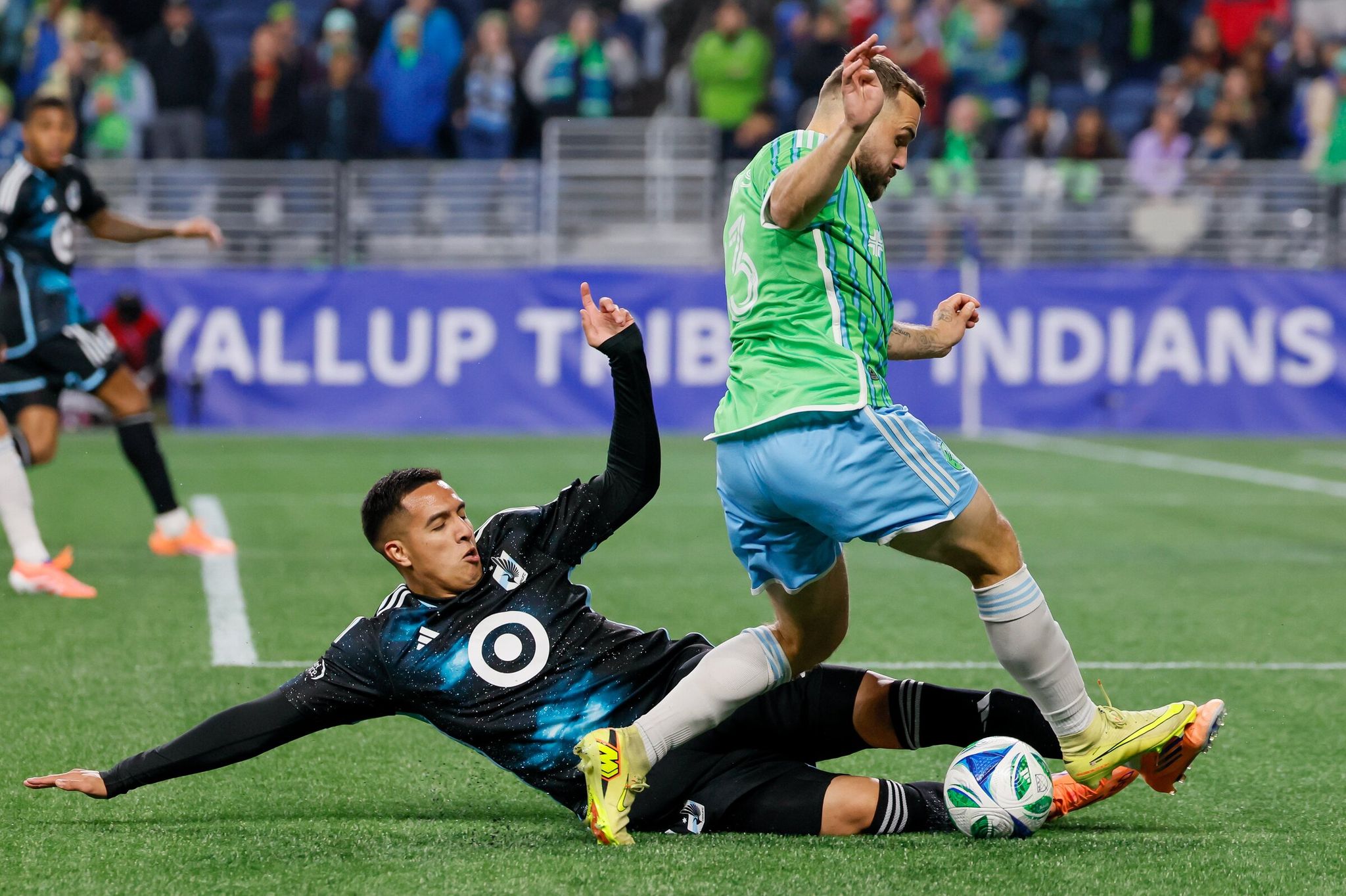 Minnesota United defender Nicolas Romero challenges Seattle Sounders FC forward Jordan Morris for the ball in the first half of the match on Monday, Nov. 3, 2025, in Seattle. (Jennifer Buchanan / The Seattle Times)