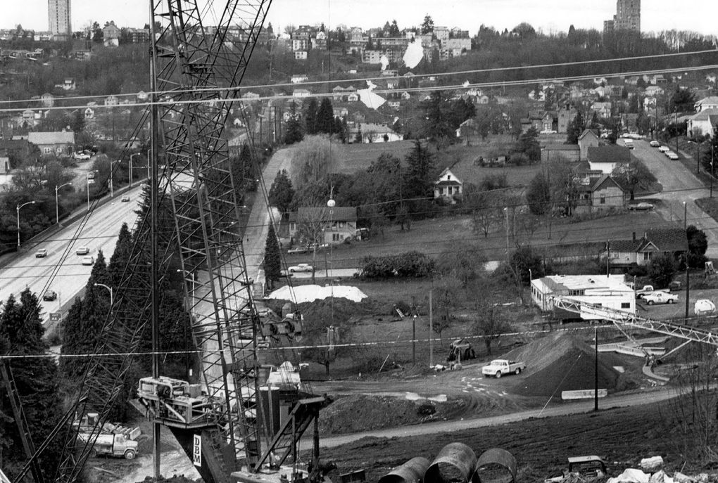 March 6, 1983: Homes and other buildings are being cleared from the path of the westbound lanes of the new Interstate 90. This view is west from Mount Baker Ridge, where construction of a big new tunnel for traffic has begun. The roadway at left connects with the present I-90 tunnels. (Richard S. Heyza / The Seattle Times)