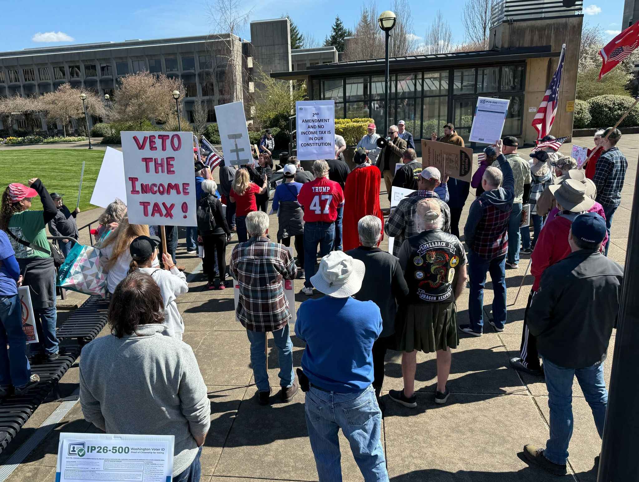 Counterprotesters gather across the street from the Capitol lawn at a rally called 'No King Ferguson' organized by the Washington State Republican Party. Protesters chanted 'no king Bob' and voiced displeasure about the state's millionaire income tax. (Shauna Sowersby / The Seattle Times)