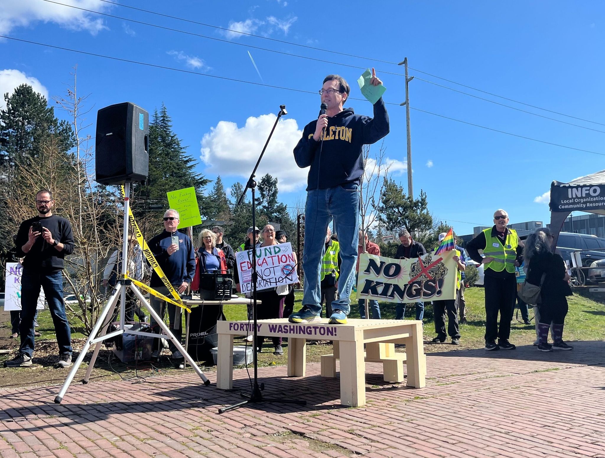 Governor Bob Ferguson made a stop at the Shoreline No Kings protest along Aurora Avenue, urging people to 'stand up for democracy' on Saturday. He praised the state's track record of suing the Trump administration. (Stephannie Stokes / The Seattle Times)