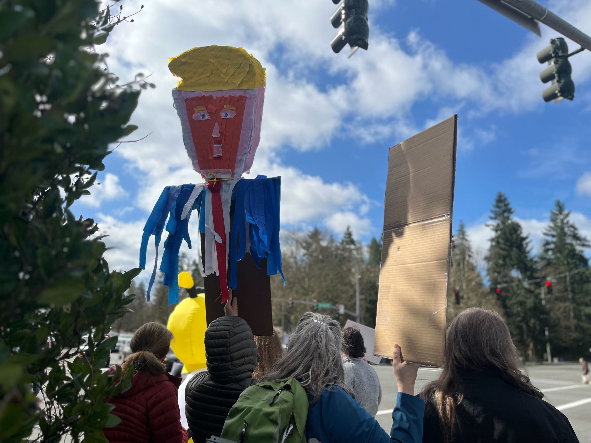 Protesters gather at the 'No Kings' action at the intersection of 148th Avenue and Bel-Red Road in Bellevue on Saturday. (Stephannie Stokes / The Seattle Times)