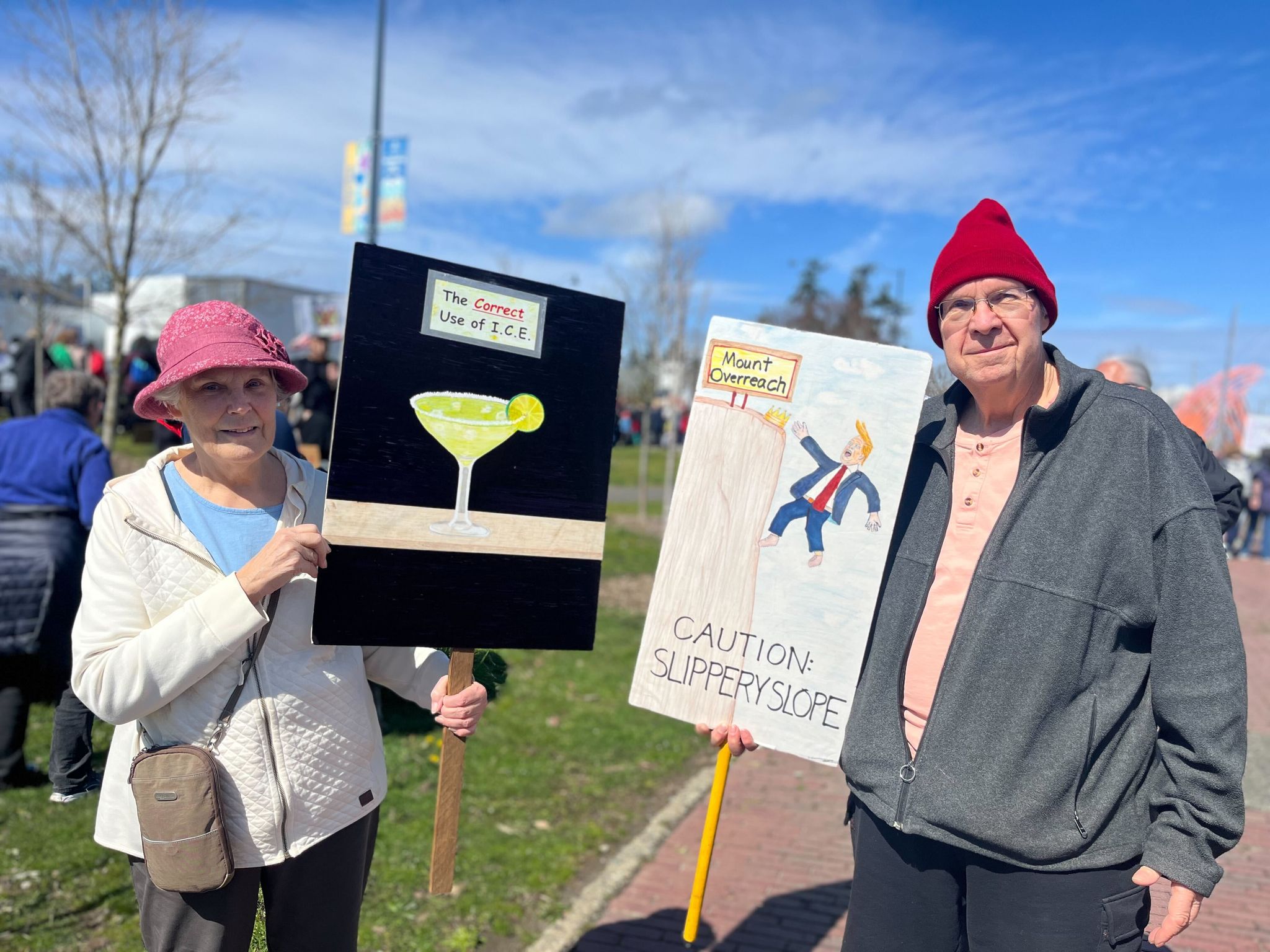 Margaret Newton and David Nerney, both 75, display their signs at the No Kings protest on March 28, 2026, in Shoreline. They said they attended as many protests as they could.