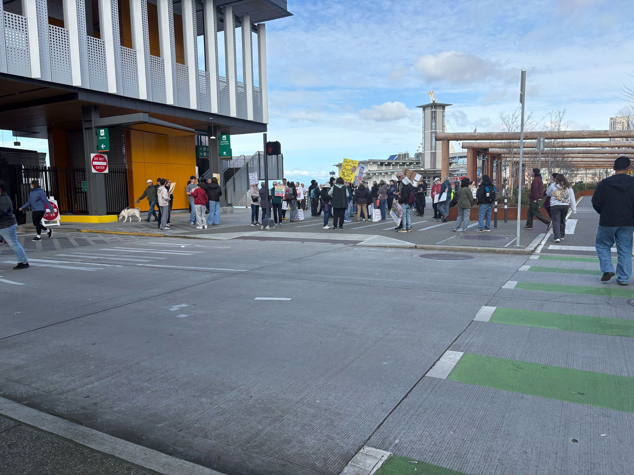 Protesters gather at Coleman Dock early Saturday. (Caitlyn Freeman / The Seattle Times)