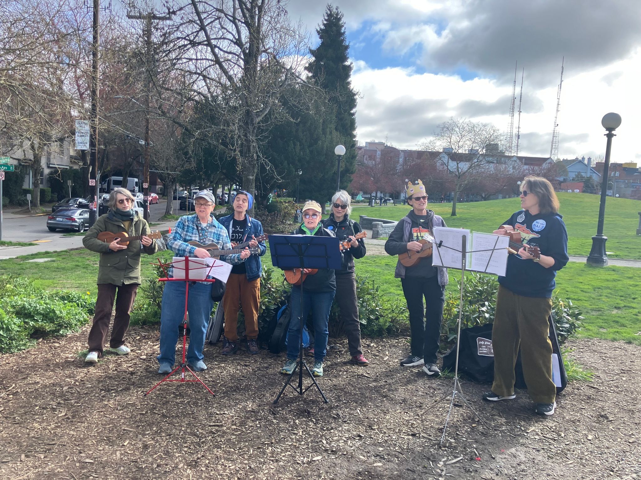 Uke Uprising plays in Cal Anderson Park as people begin arriving for Saturday's No Kings protest. (Nina Shapiro / The Seattle Times)