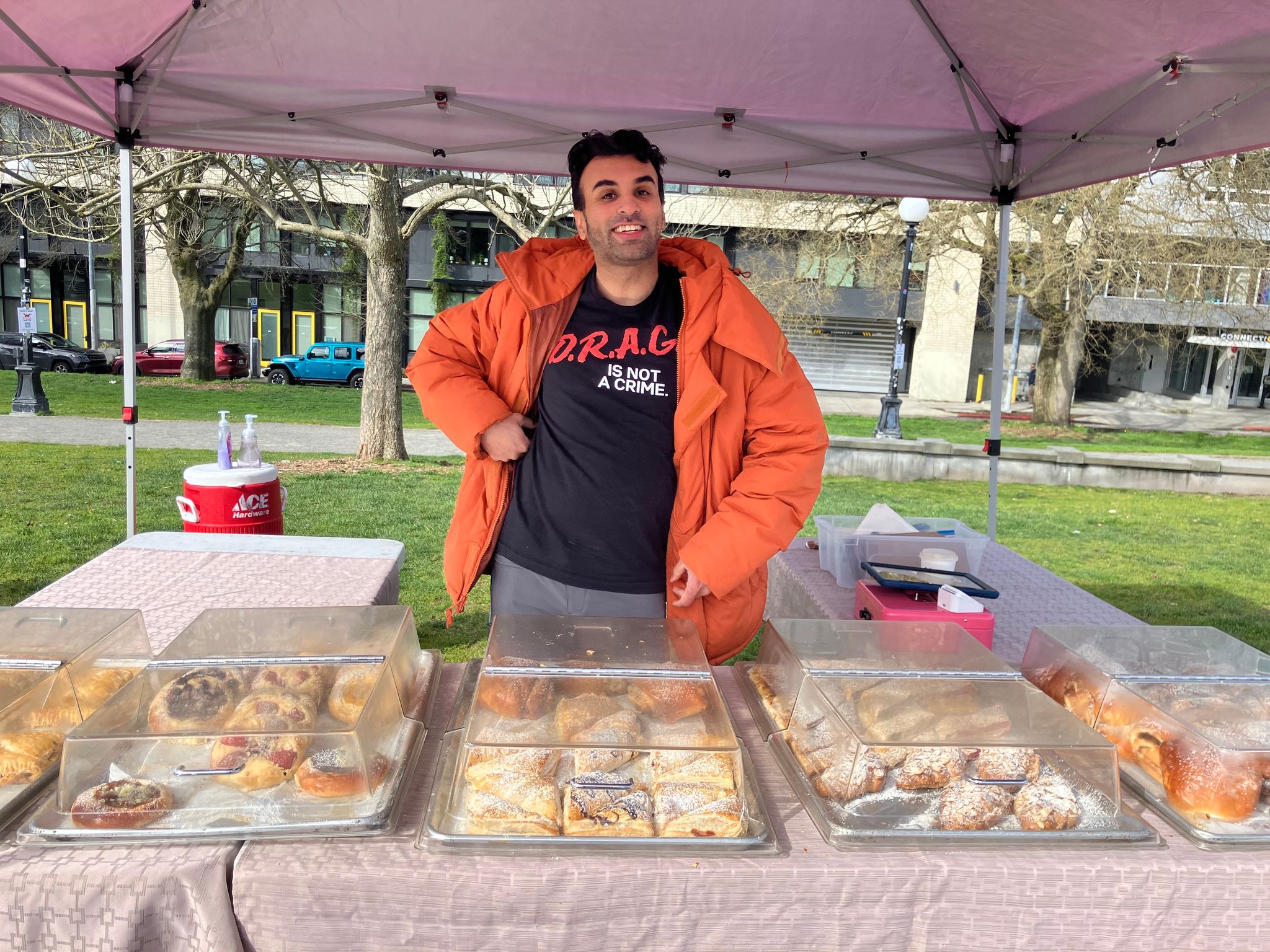 Sahil Sharma of Little Prague European Bakery arranges his goods on Saturday, March 28, in Cal Anderson Park for the No Kings rally. He usually sells food in the University District on Saturdays but decided to change locations to add 'a little sweetness' to the world's 'hopelessness.'