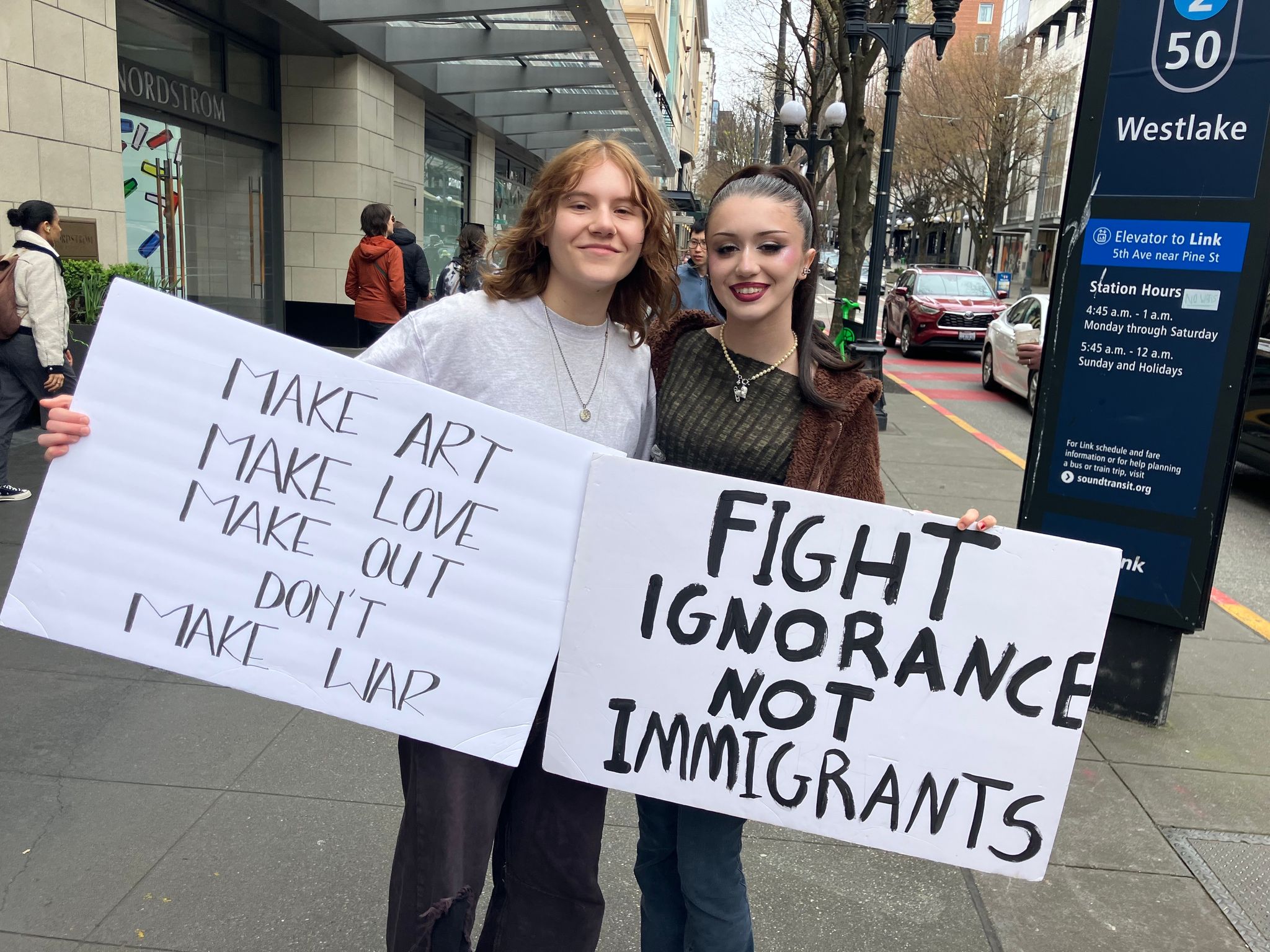 Anna Emter, 20, left, and Monroe Shirley, 18, on their way to Seattle Center on Saturday.
