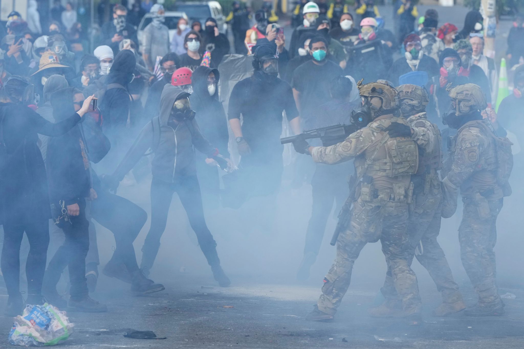 U.S. Customs and Border Protection agents standoff against demonstrators as tear gas fills the air outside the U.S. Immigration and Customs building during a protest in Portland, Ore., June 14, 2025. (Jenny Kane / The Associated Press, file)