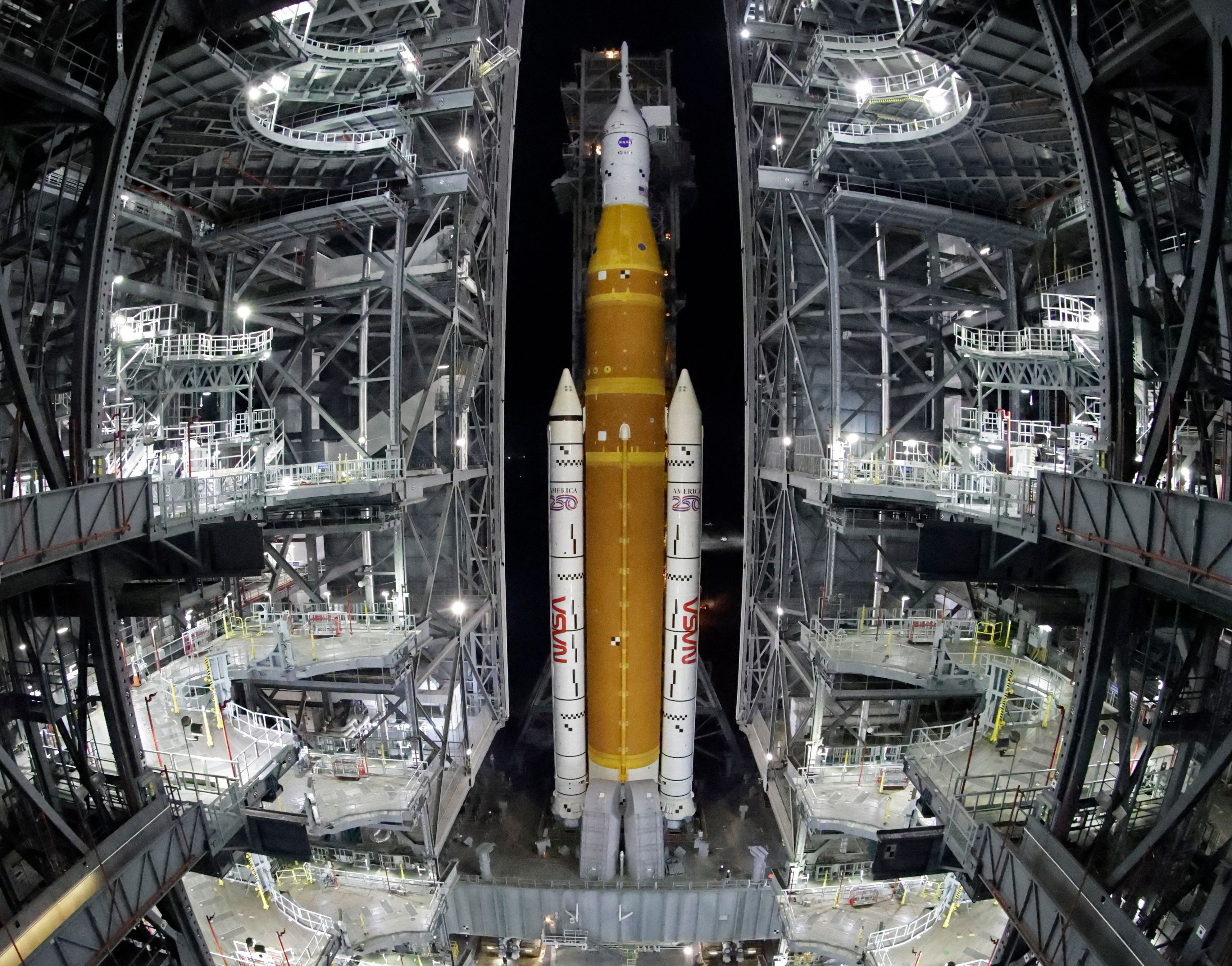 NASA hauls its repaired moon rocket from the hangar back to the