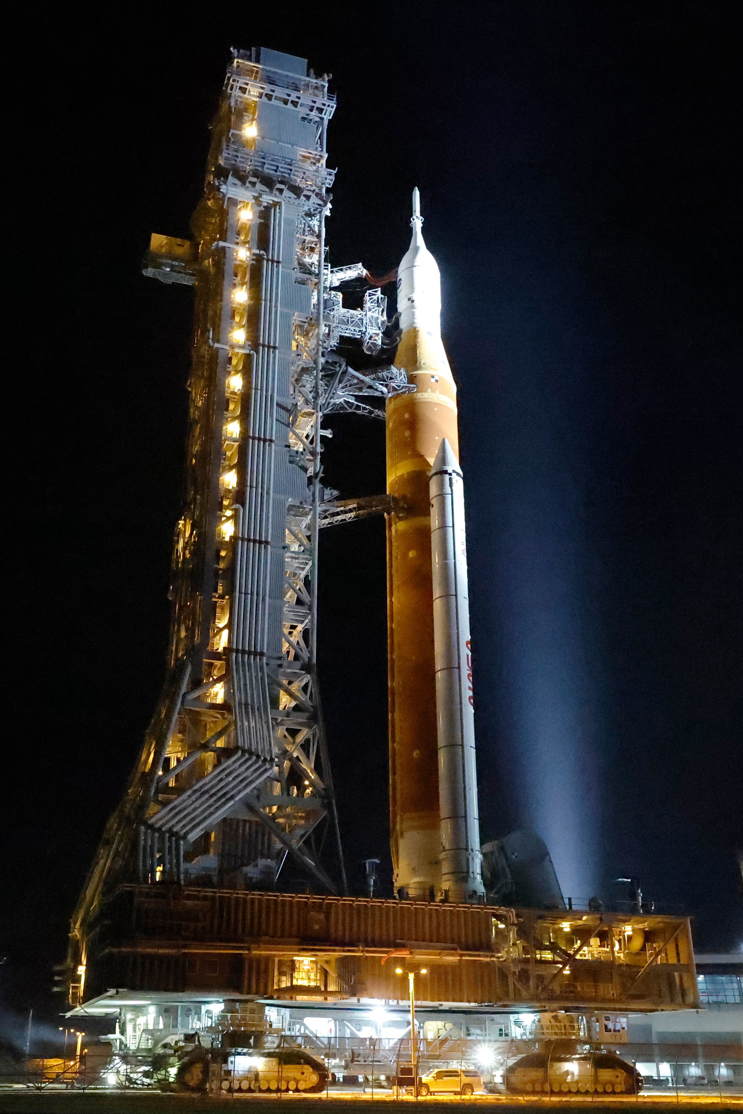 NASA hauls its repaired moon rocket from the hangar back to the