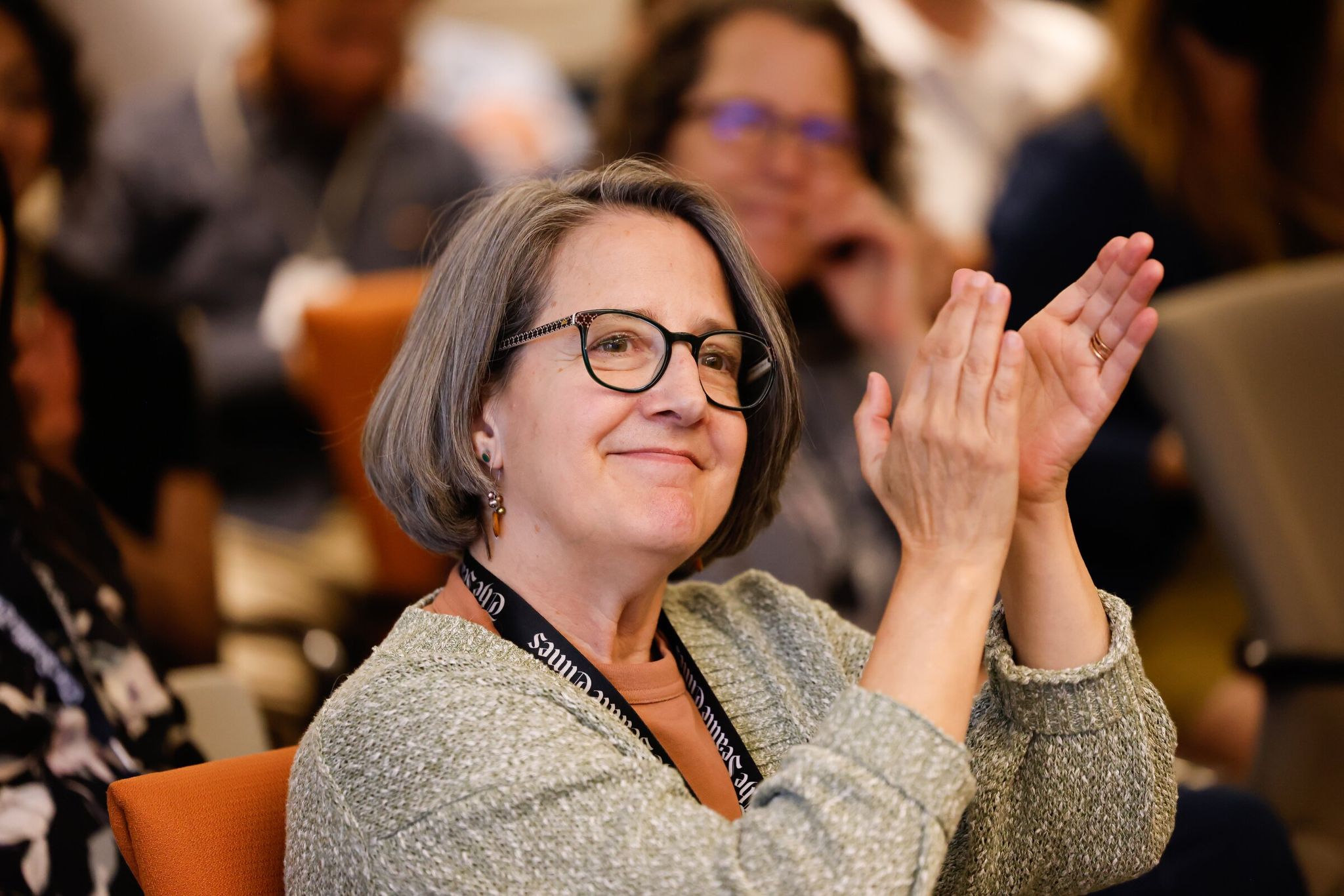 The Seattle Times managing editor Lynn Jacobson applauds during a company celebration on June 13, 2024. Jacobson retires Friday after more than 30 years at The Seattle Times. (Karen Ducey / The Seattle Times, 2024)