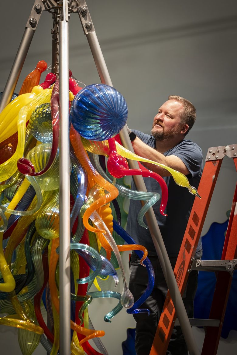 Rick Holland builds the “End of the Day Chandelier” at a Chihuly Studio location in Seattle in 2025. (Nathaniel Willson)