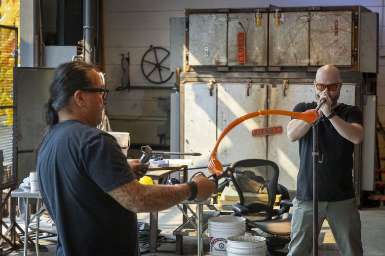 Emmanuel Aguilera-Santos and James Thrash at the hotshop in The Boathouse, Dale Chihuly’s studio at Lake Union, in 2025. (Nathaniel Willson)