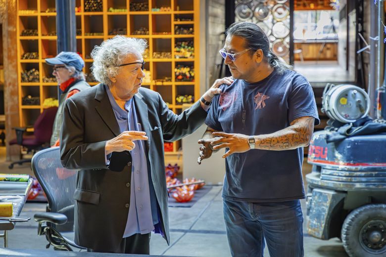 Dale Chihuly and Emmanuel Aguilera-Santos in the hotshop at The Boathouse, Chihuly’s Lake Union studio, in 2024. (Nathaniel Willson)