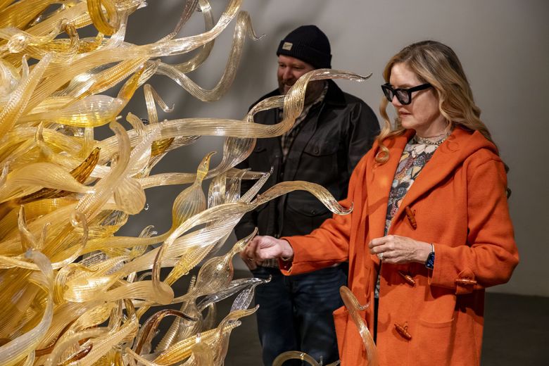 Rick Holland and Leslie Jackson Chihuly review “Gold Tower” at a Chihuly Studio location in Seattle in 2025. (Nathaniel Willson)