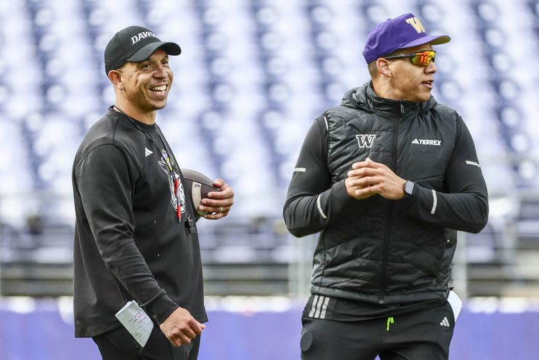 Ryan Walters, left, defensive coordinator, with Taylor Mays, safeties coach, Thursday afternoon on the practice field in Seattle, Washington on April 2, 2026. (Kevin Clark / The Seattle Times)