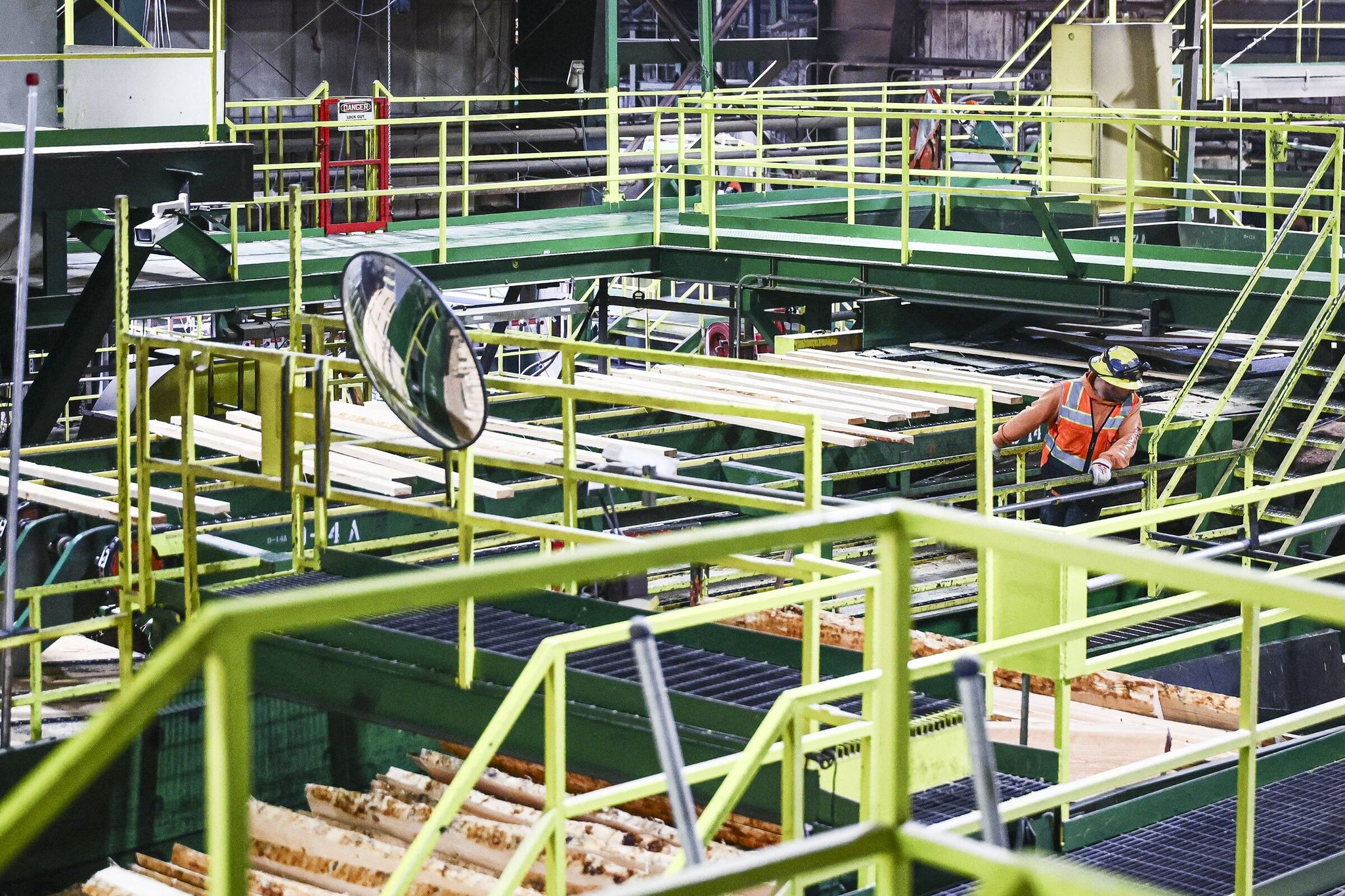 A mill worker monitors the passage of lumber on the Hampton Lumber mill line in Morton, Lewis County, last month. Employment in U.S. sawmilling and wood product sectors continues to decline — about 85,000 workers, the lowest level since 2013, according to the National Association of Home Builders. (Kevin Clark / The Seattle Times)