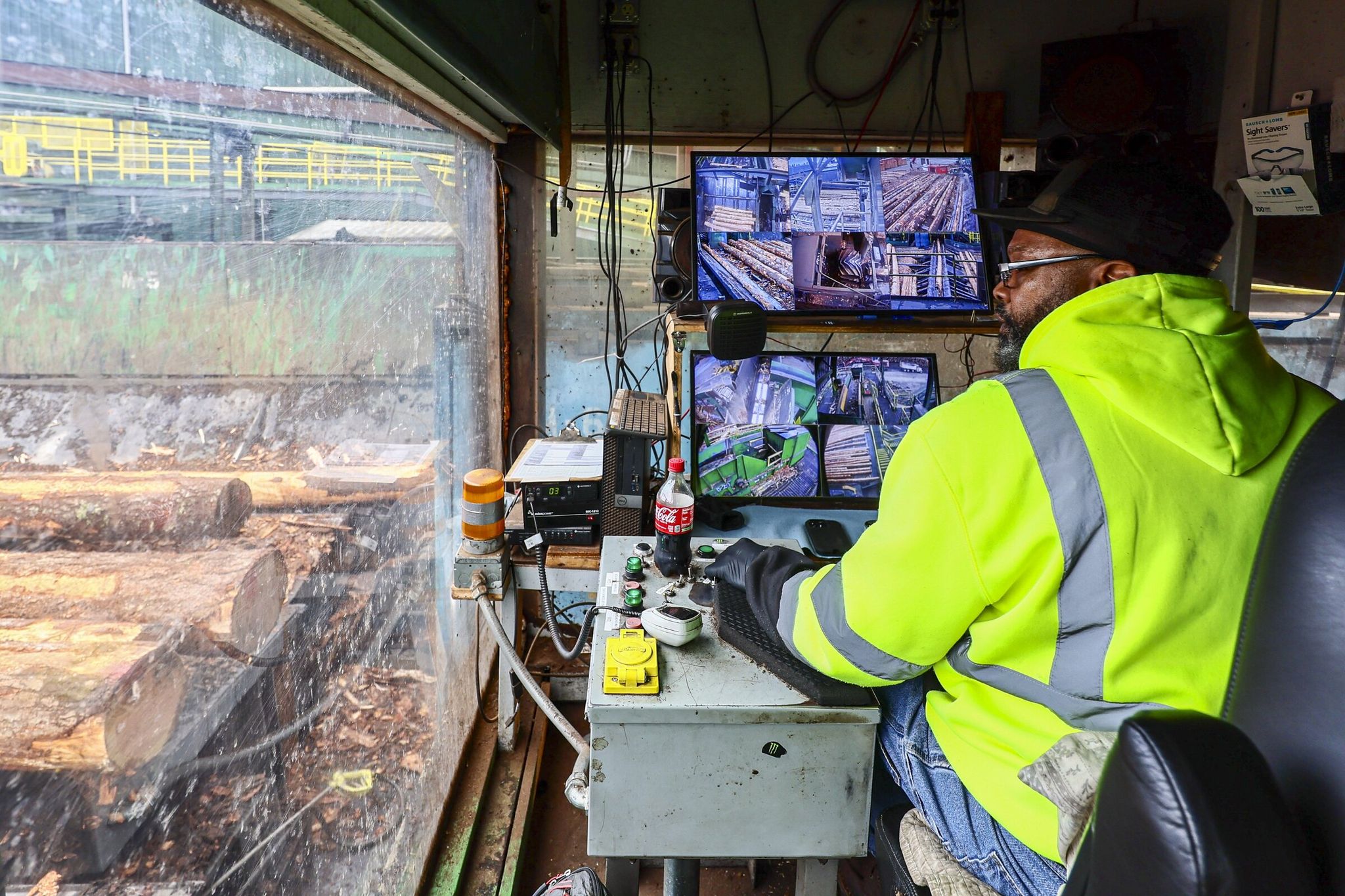 Tony Johnson oversees incoming raw timber at the Hampton Lumber plant in Morton, Lewis County, last month. Local demand for lumber has also fallen along with a recent slowdown in housing activity across the state. (Kevin Clark / The Seattle Times)