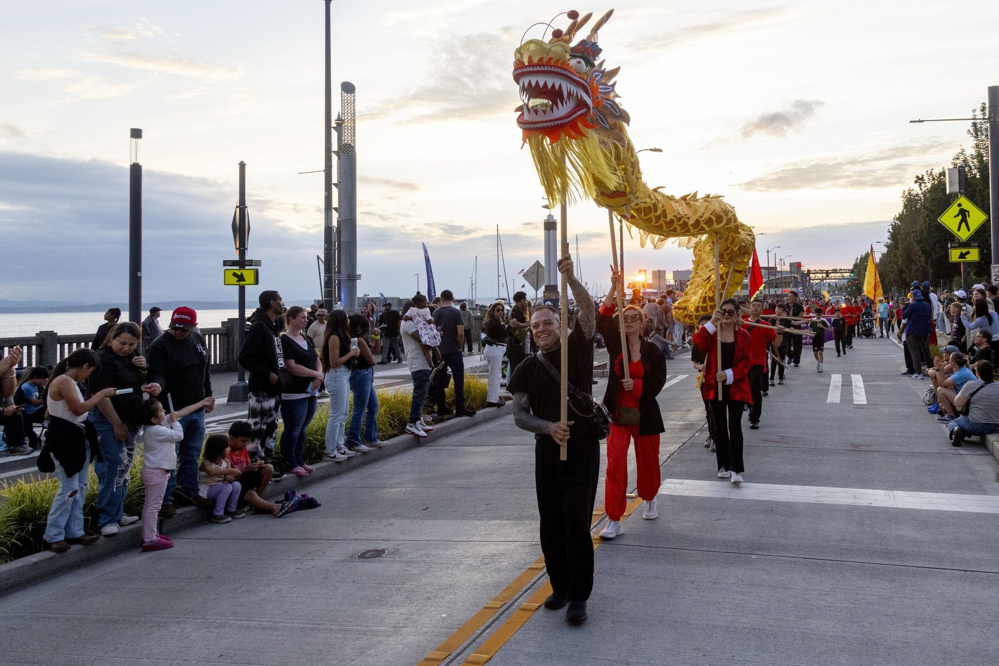 Spectators watch the Alaska Airlines Seafair Torchlight Parade pass through downtown Seattle on July 26. (Akash Parmar / The Seattle Times)