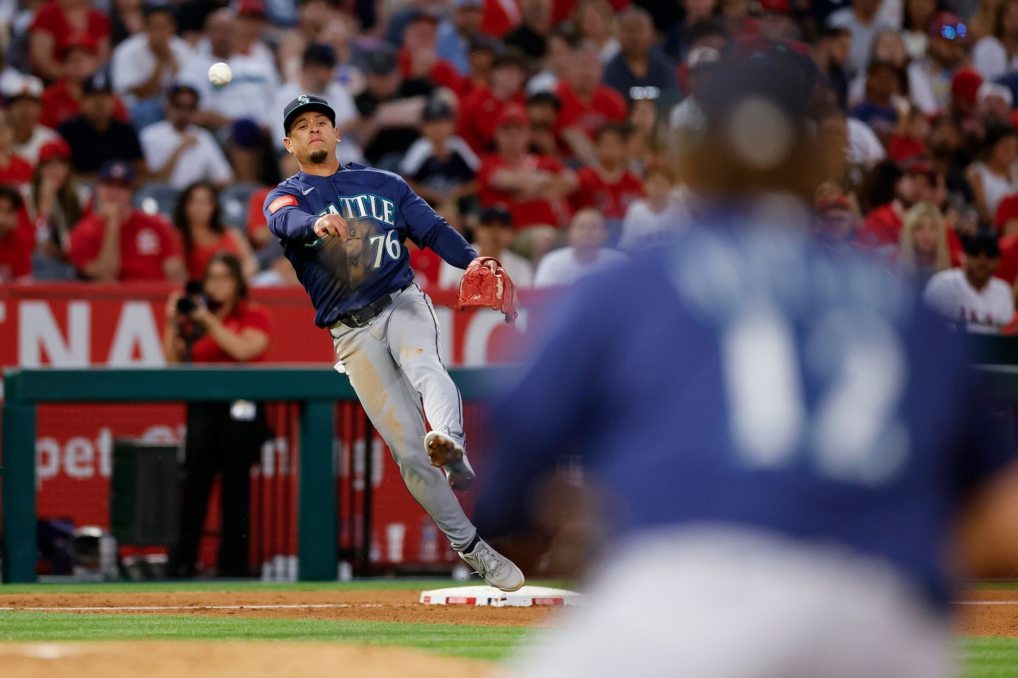 Third baseman for the Seattle Mariners Leo Rivas (76) throws to first base to retire Los Angeles Angels’ player Oswaldo Peraza (not shown) during the third inning of the baseball game on Saturday, April 4, 2026, in Anaheim, California. (Caroline Breckman / The Associated Press)