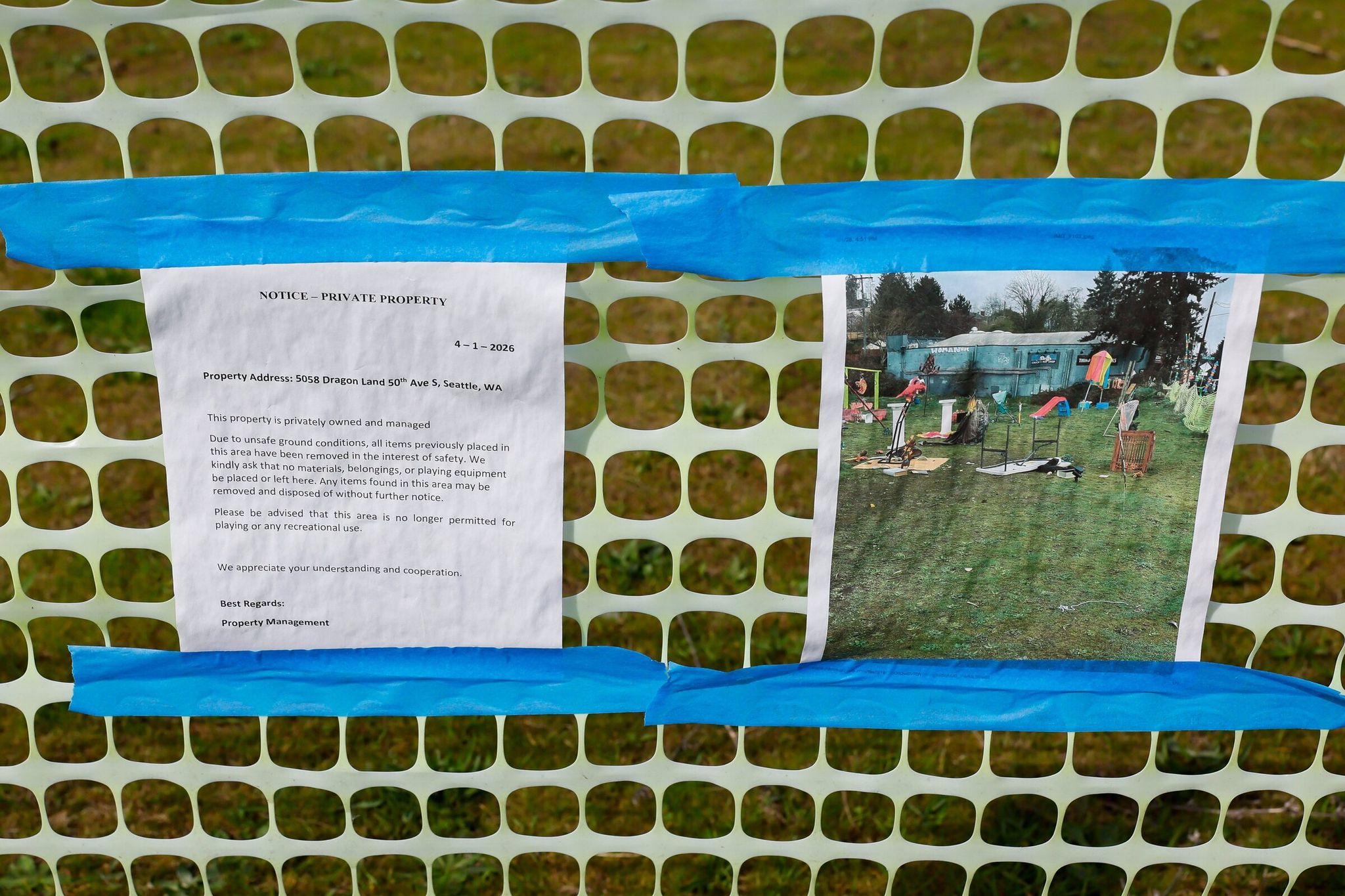 A private property notice taped to a temporary fence Monday at the South Seattle lot that had hosted the guerrilla art exhibit called “Dragon Land.” (Jennifer Buchanan / The Seattle Times)