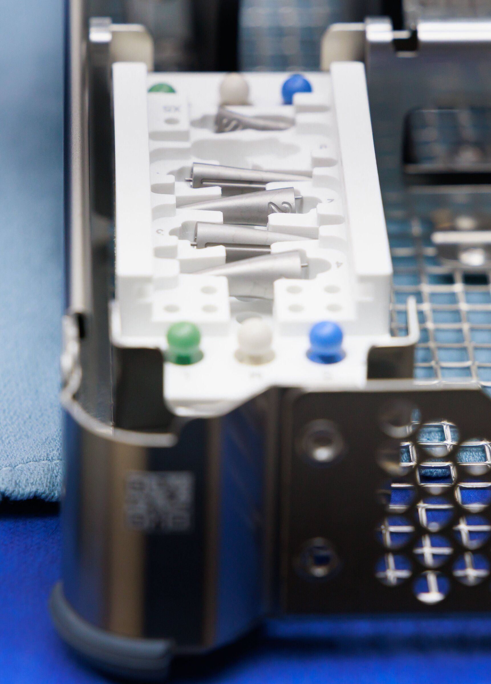 A set of trial implants that surgeons use to determine the best fit before placing the final prosthesis sits on a side table filled with surgical instruments in the operating room at University of Washington Medical Center — Roosevelt. (Erika Schultz / The Seattle Times)