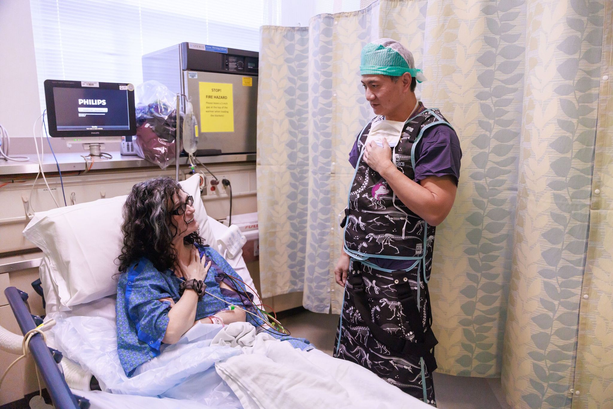 Erika Clancy talks with Dr. Jerry Huang, who has treated her for 10 years, before her thumb joint replacement last week at UW Medical Center — Roosevelt in Seattle. The procedure aims to help thumb arthritis patients recover faster and reduce pain. (Erika Schultz / The Seattle Times)