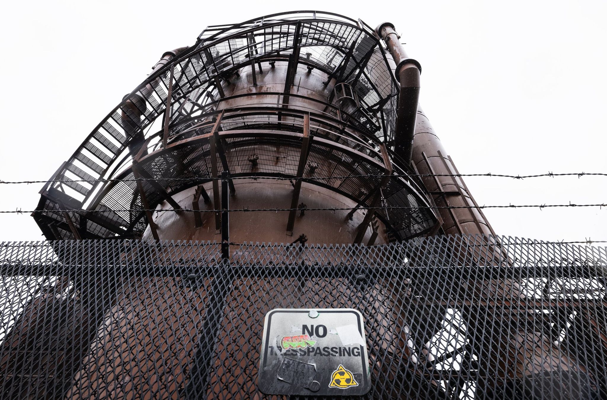Fenced-off, aging metal structures in Gas Works Park, which sits on the site of a former coal gasification plant. (Ken Lambert / The Seattle Times)