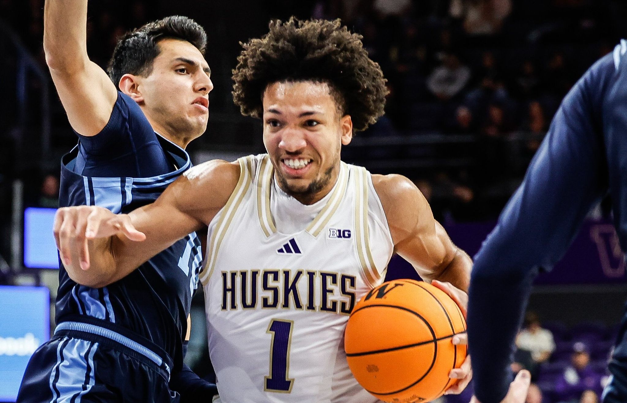 Washington player Desmond Claude drives to the paint in a game against the University of San Diego, Monday, Dec. 22, 2025, at the Alaska Airlines Arena in Seattle. (Dein Rutz / The Seattle Times)