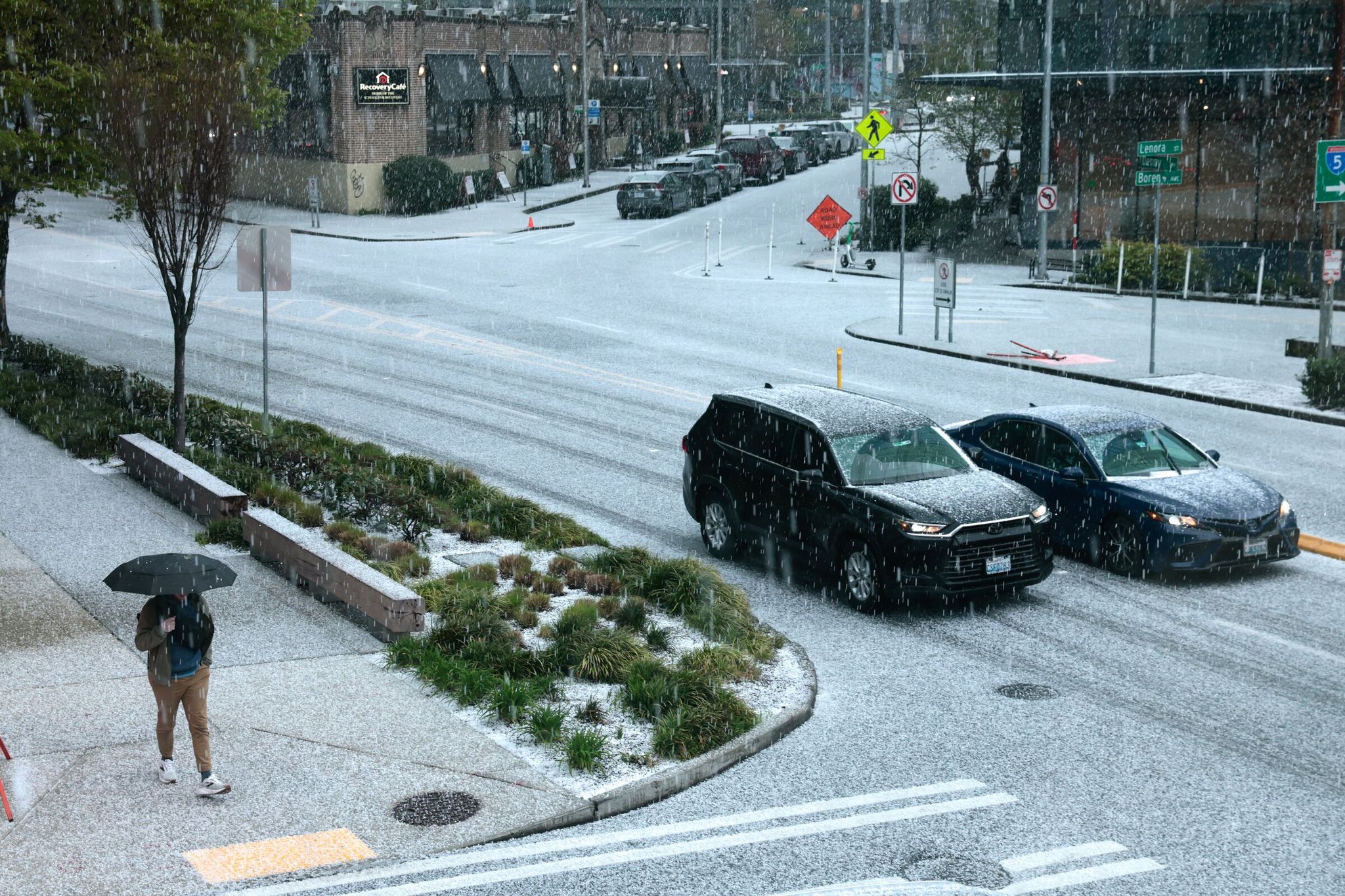 Hail covers Denny Way in Seattle on Wednesday afternoon. (Karen Ducey / The Seattle Times)