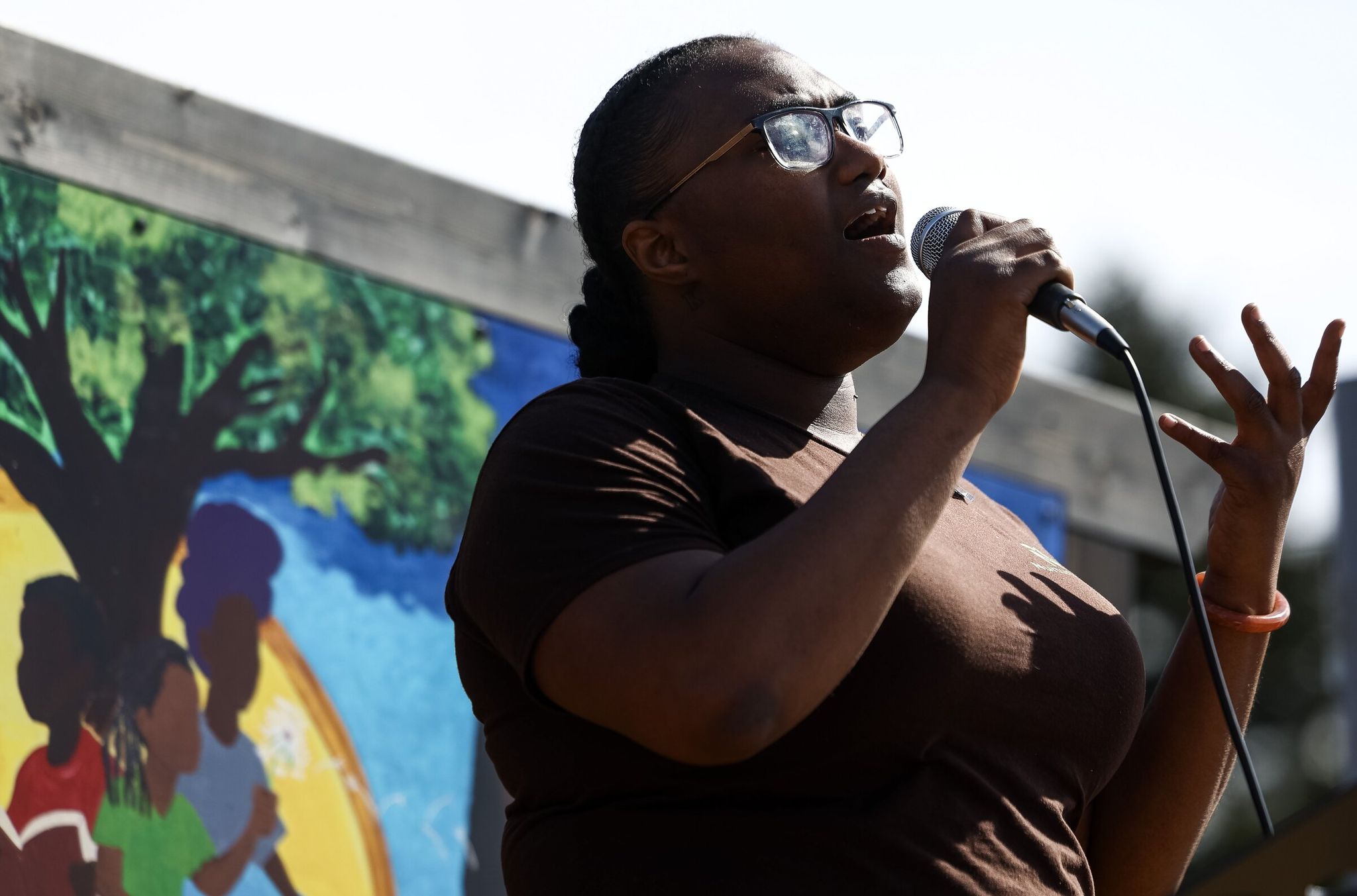 Jaysa Duhon sings 'Lift Every Voice and Sing' in the new park on Sunday. (Nick Wagner / The Seattle Times)