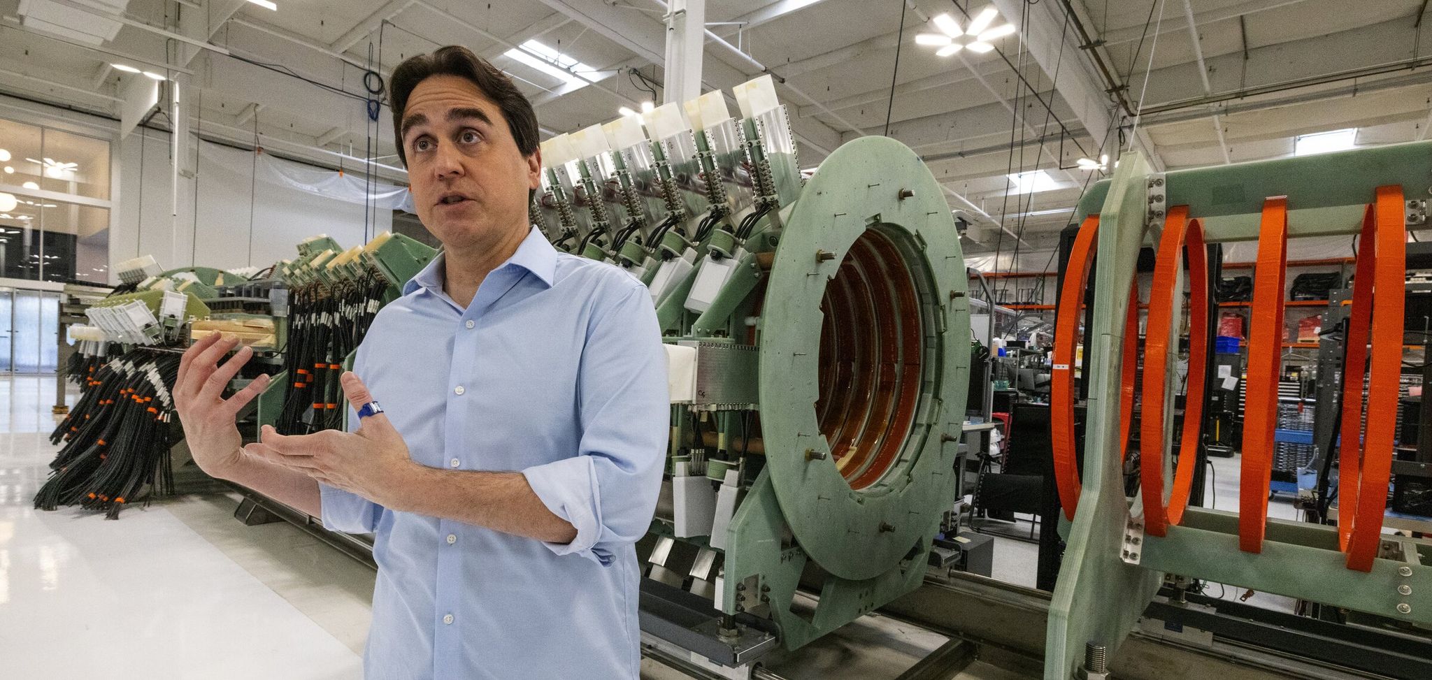 Helion CEO David Kirtley explains a prototype fusion device that is now decommissioned. The Everett fusion energy company has a contract to supply Microsoft with power by 2028. (Ken Lambert / The Seattle Times)