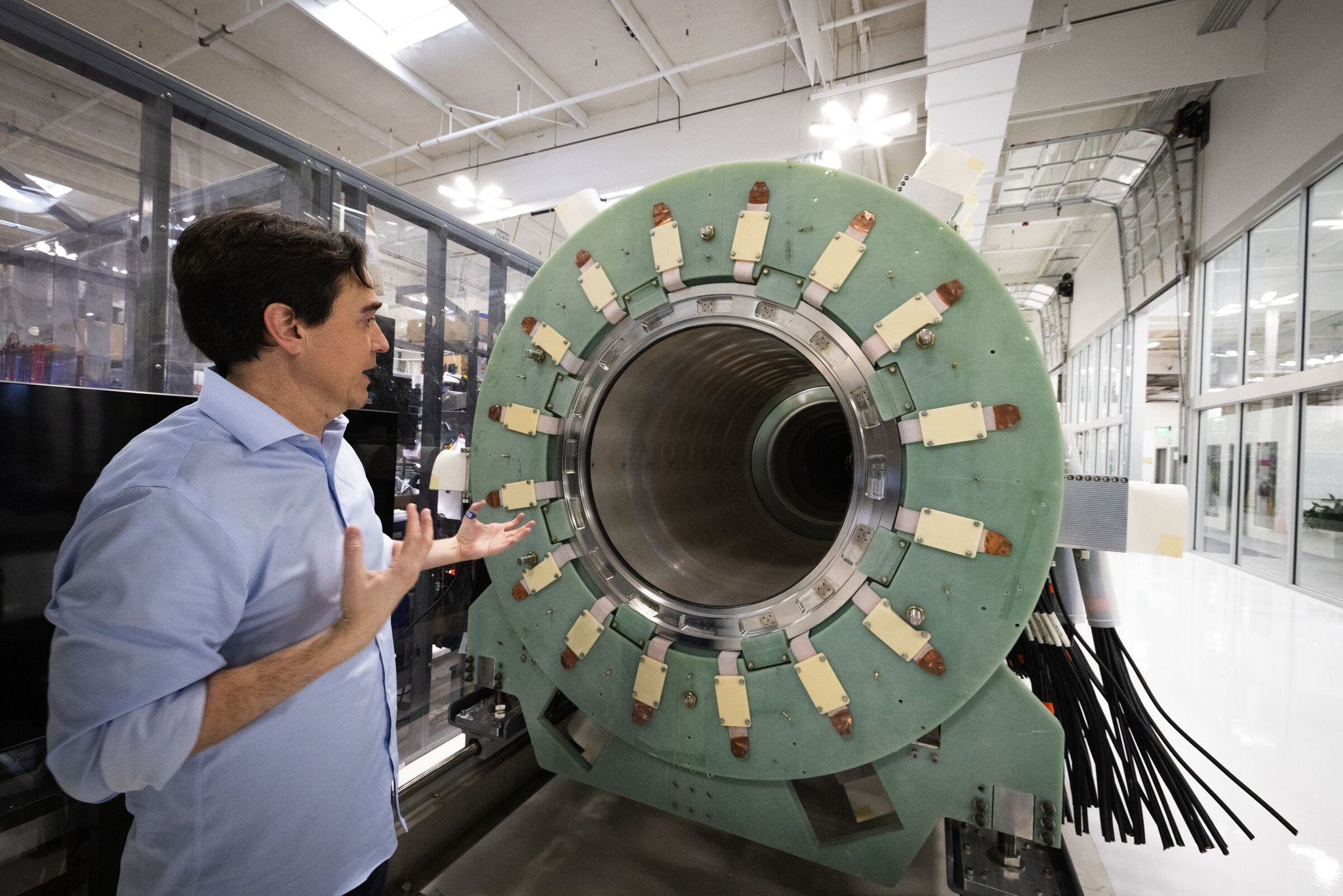 David Kirtley, CEO of Helion, explains a decommissioned prototype fusion reactor at the company’s fusion manufacturing site in Everett. The company has a contract to supply fusion power to Microsoft by 2028. (Ken Lambert / The Seattle Times)