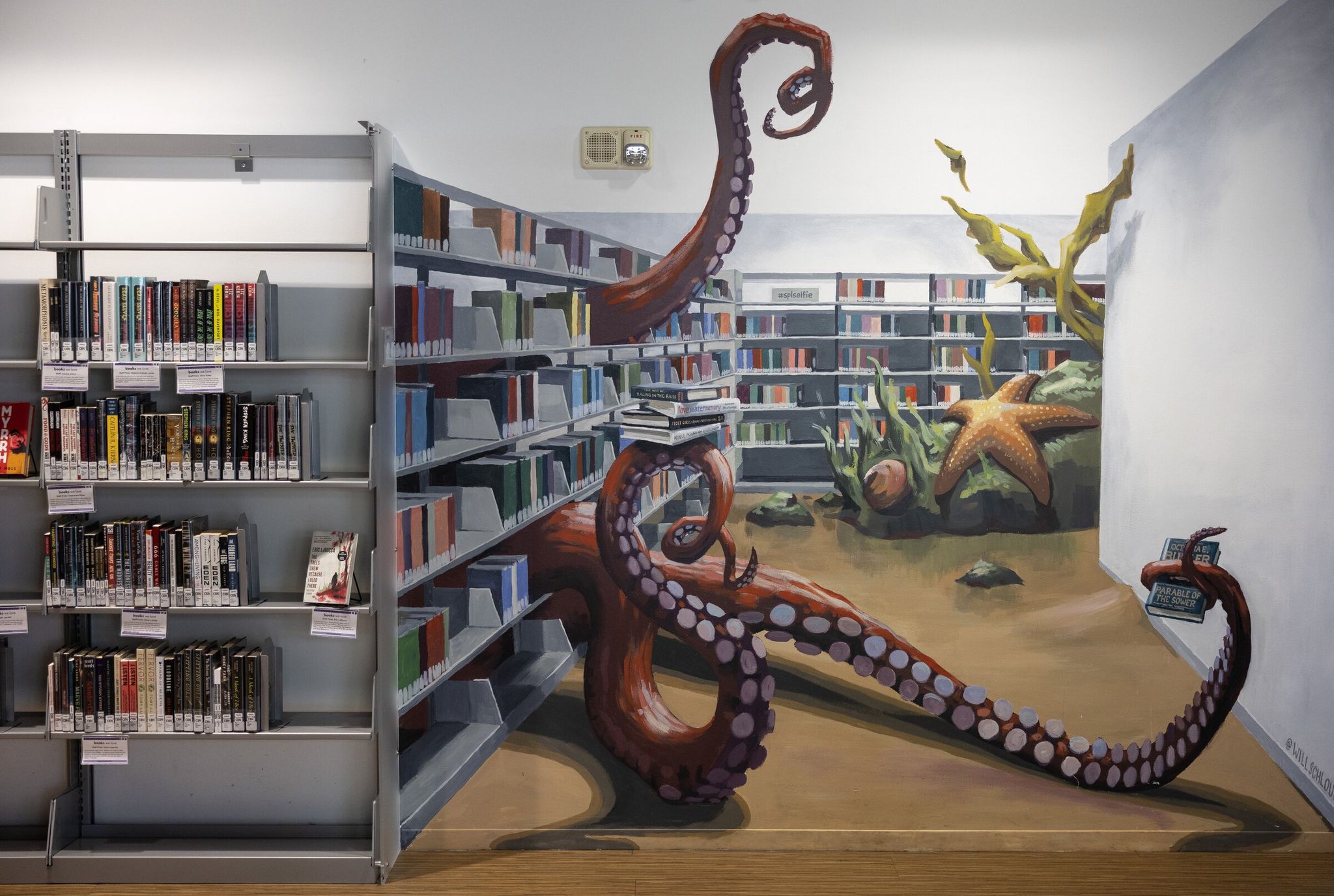 The “Underwater Mural” painted by Seattle artist Will Schlough is seen at SPL’s Central Library. (Nick Wagner / The Seattle Times, 2025)