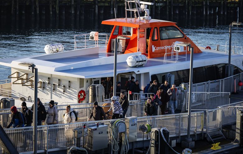 Kitsap Transit Fast Ferries passengers walk off the vessel Reliance from Bremerton and onto Pier 50 in downtown Seattle. Kitsap County is the rare place voters approved a sales tax increase for three routes to Seattle from Kingston, Bremerton and Southworth. (Ken Lambert / The Seattle Times, 2025)