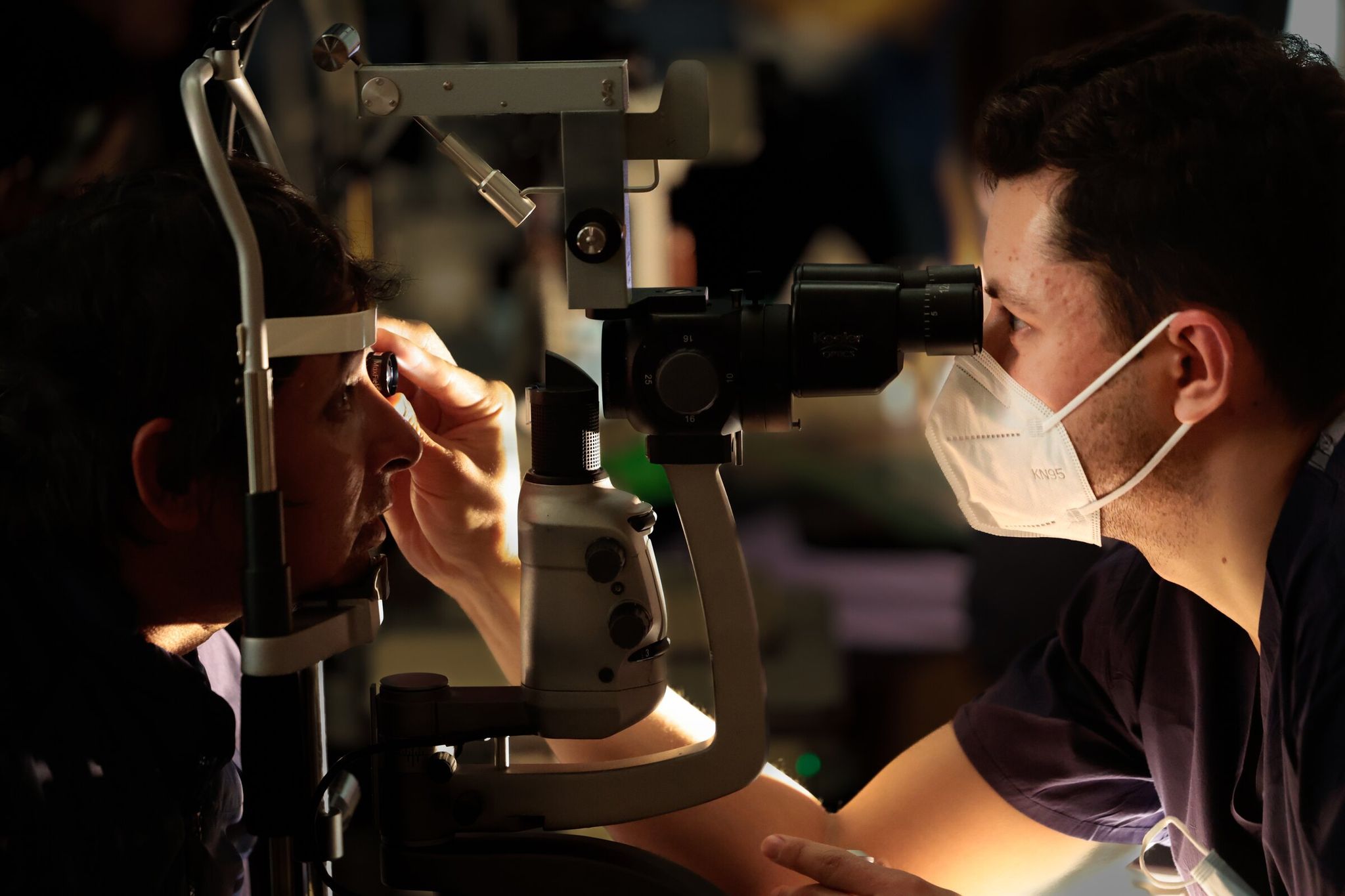 Sergio Lemus (left) checks vision with Dr. Marcus Turner (right) at the Seattle/King County clinic on Thursday. (Karen Ducey / The Seattle Times)