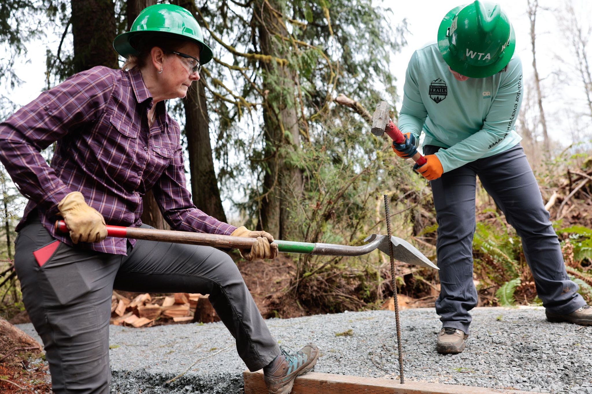 Lianne Underwood of Sultan, left, and Kindra Ramos of Everett join other WTA volunteers who built a new ADA-accessible loop trail last month near Lake Cassidy. (Karen Ducey / The Seattle Times)