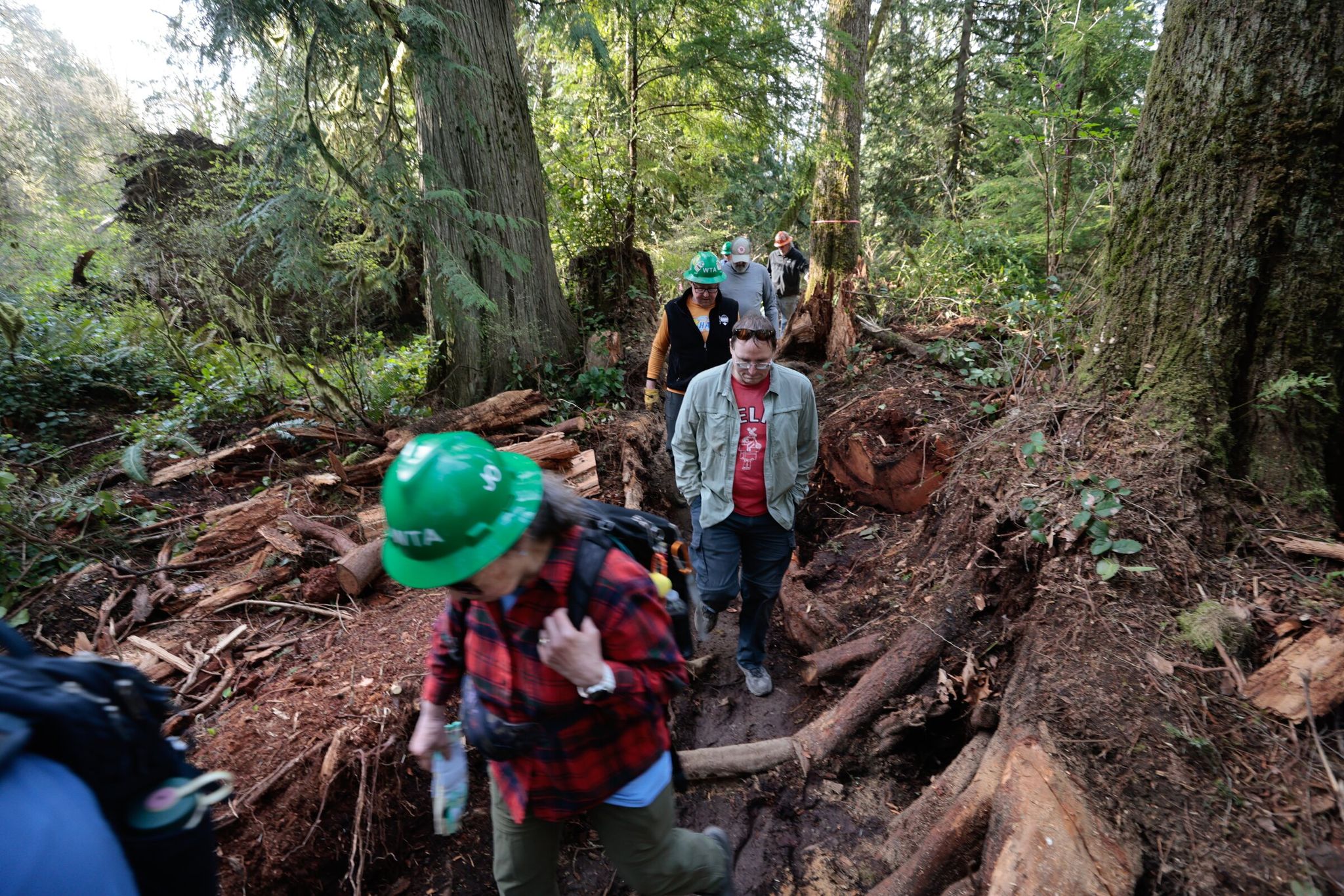 A crew of volunteers with the Washington Trails Association builds a new Americans with Disabilities Act-accessible loop trail near Lake Cassidy, connecting to the Centennial Trail, in Lake Stevens in April. (Karen Ducey / The Seattle Times)