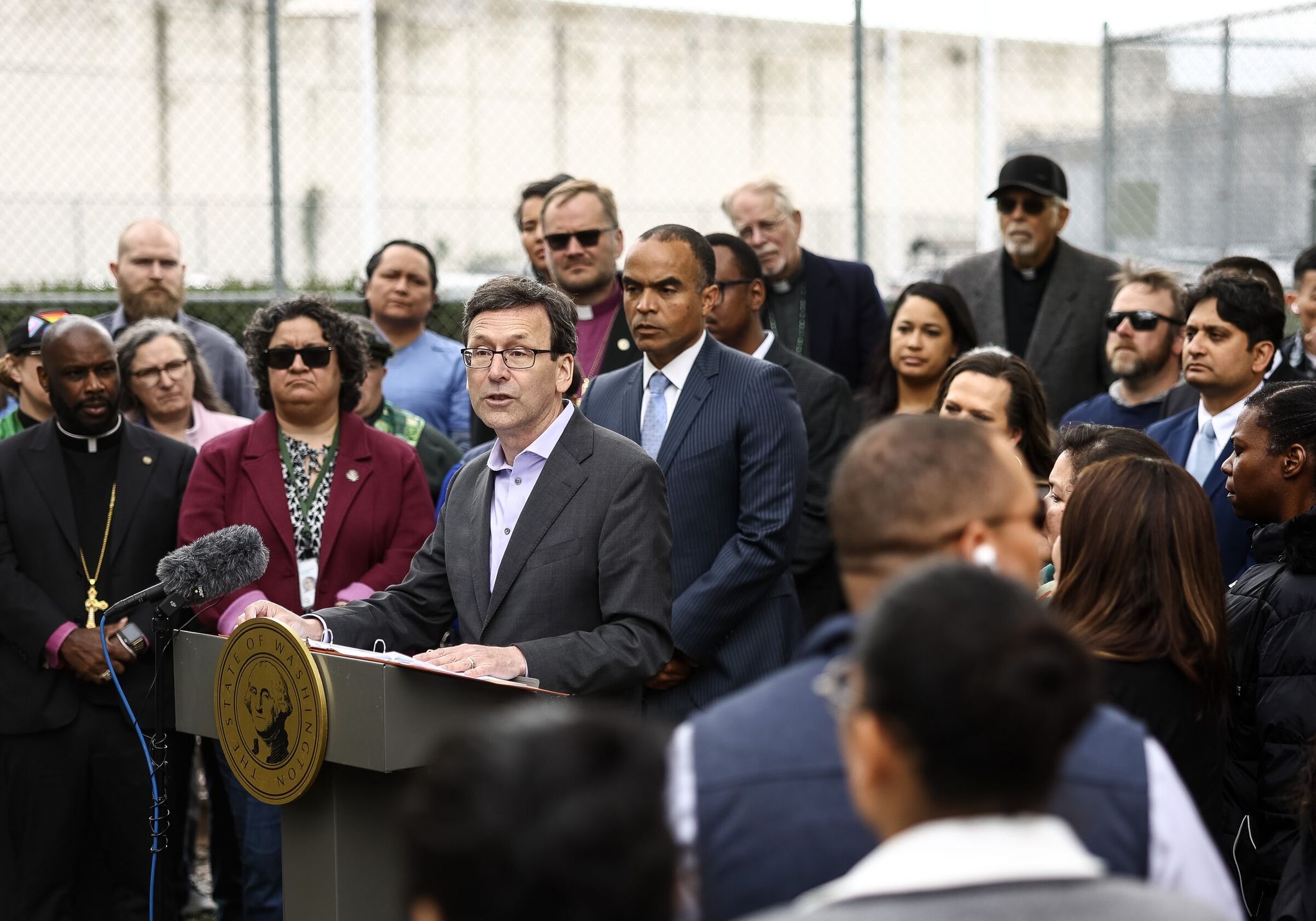 Gov. Bob Ferguson speaks during a news conference outside the Northwest ICE Processing Center in Tacoma on Tuesday. (Nick Wagner / The Seattle Times)