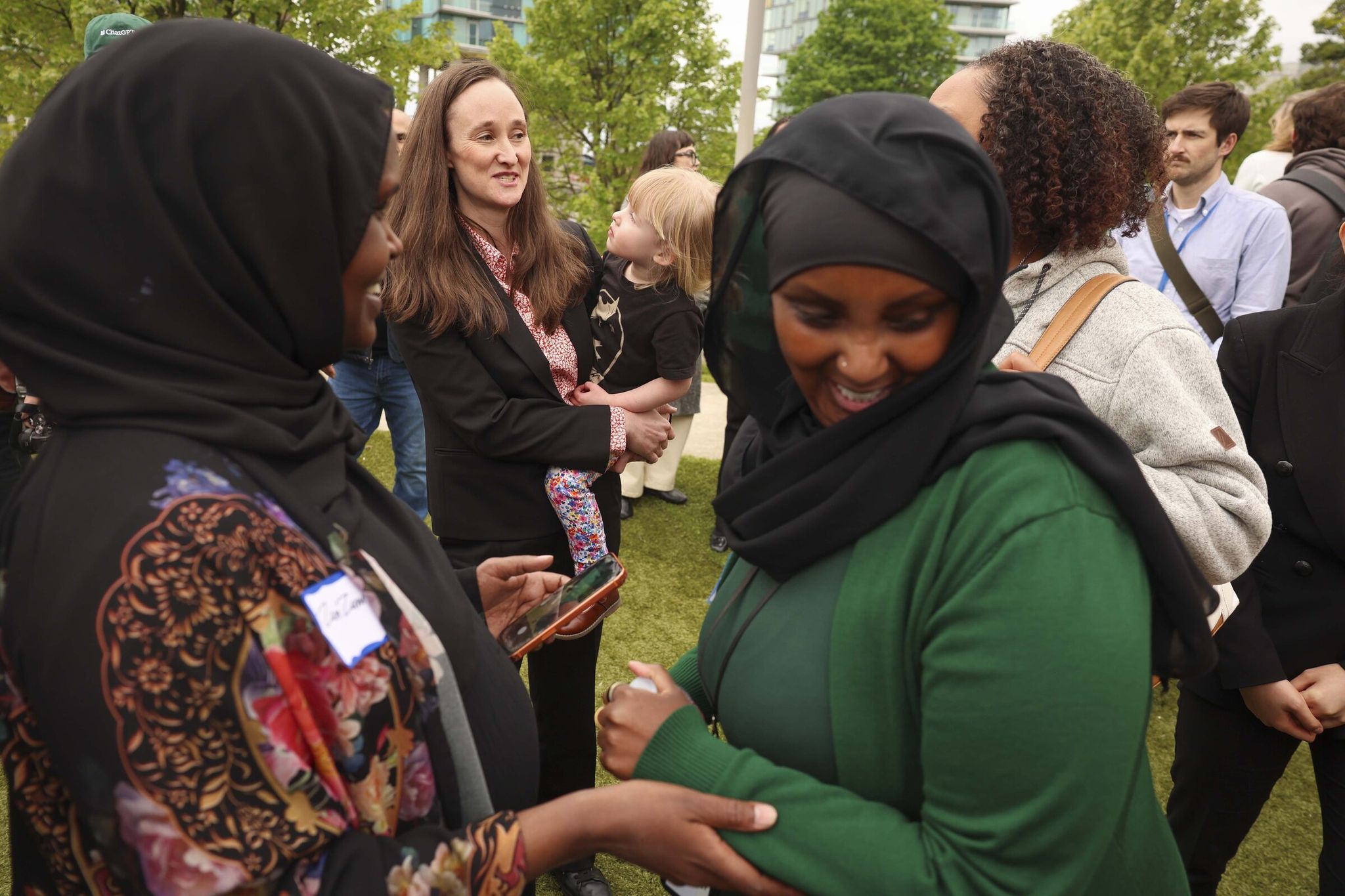Seattle Mayor Katie Wilson speaks with community members Tuesday after announcing a plan for the Families, Education Preschool and Promise levy at Yesler Terrace Park. (Ivy Ceballo / The Seattle Times)