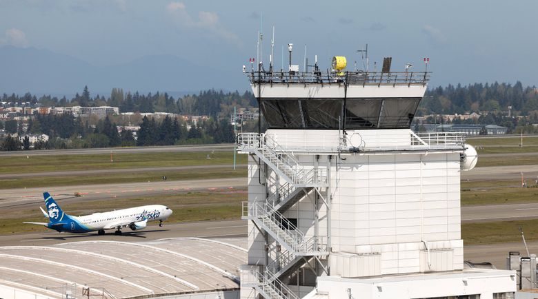 An Alaska Air plane takes off in front of the ramp tower at the Seattle-Tacoma International Airport last month. Nearly 1,200 aircraft take off and land at the airport every day. (Karen Ducey / The Seattle Times)