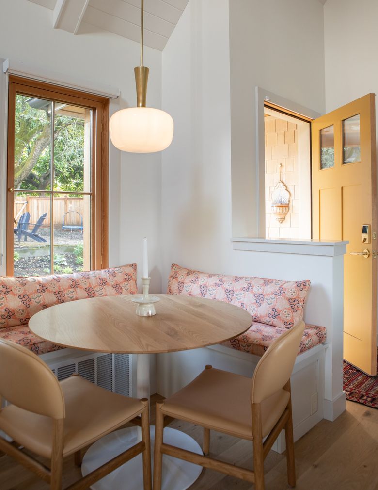 A built-in dining nook saves space, as does a rolling library ladder that leads to a sleeping loft, where grandchildren can spend the night. (Melissa Kaseman / Courtesy of Lauren Crocco A+D)