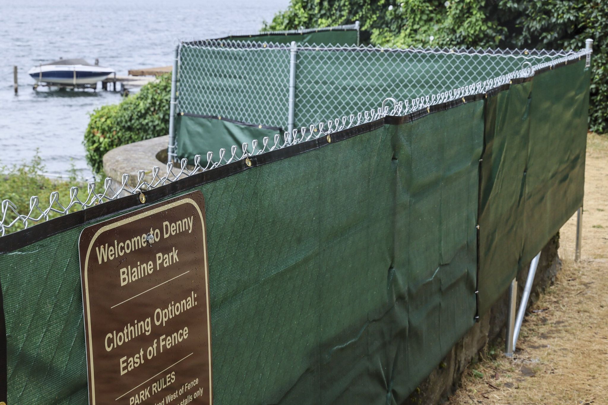 A judge ruled May 1 that toplessness is allowed at Denny Blaine Park in both “clothing required” and “clothing optional” zones, separated by a fence. (Kevin Clark / The Seattle Times)