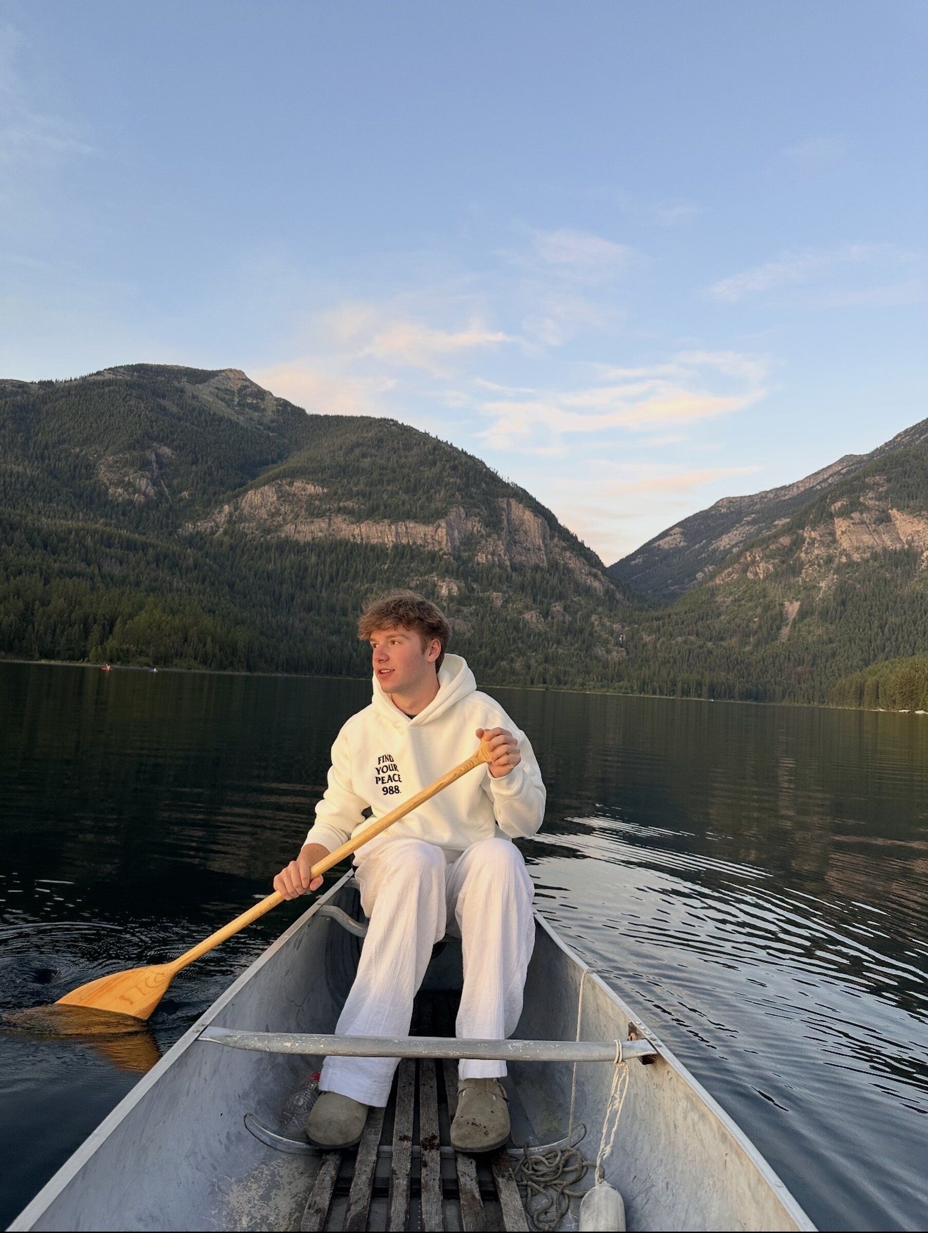 Ronan Buckley canoes in Montana in July 2025, wearing a 988 Find Your Peace hoodie. (Courtesy of Ronan Buckley)