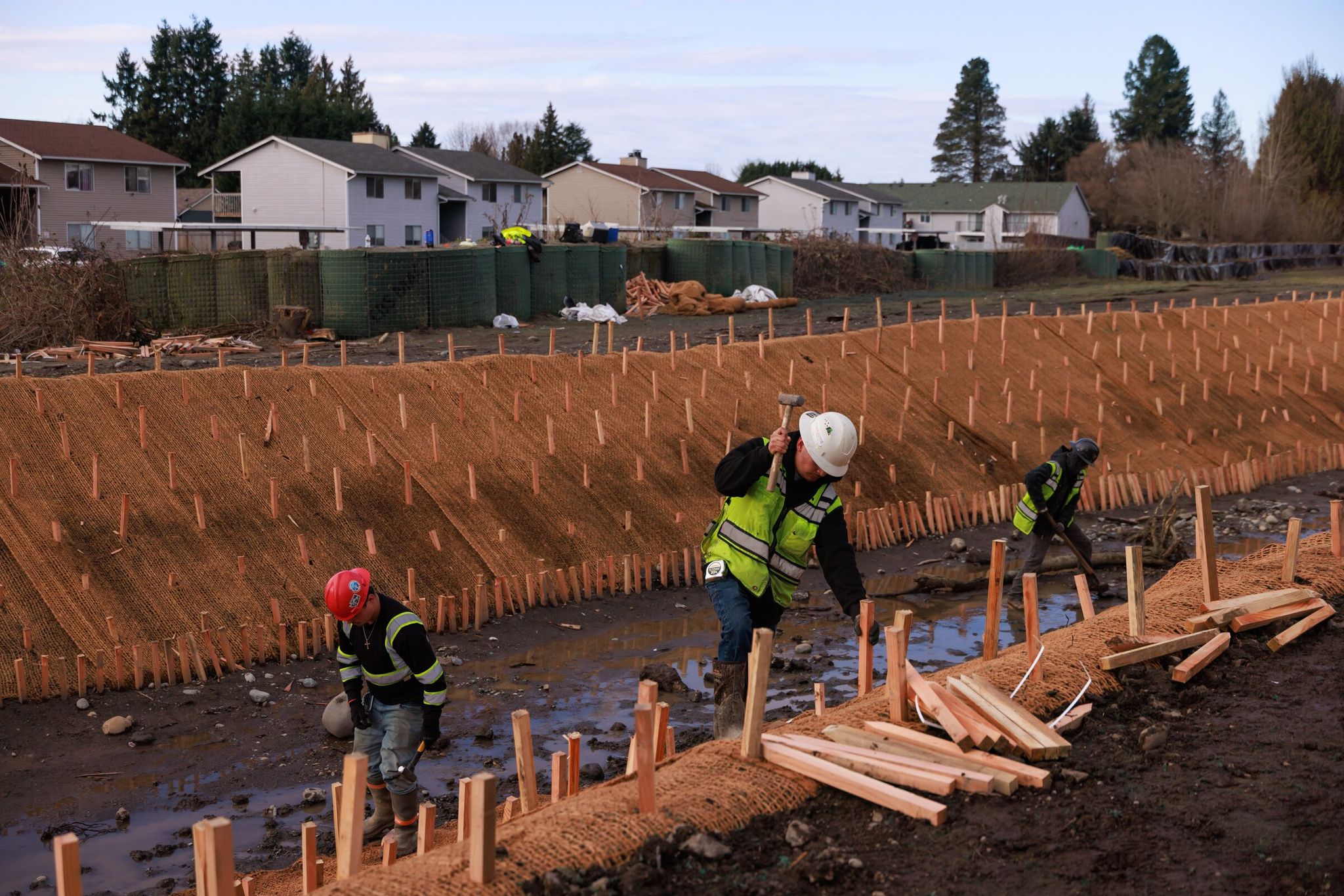 A crew works at Pacific City Park after the December flood. (Erika Schultz / The Seattle Times)